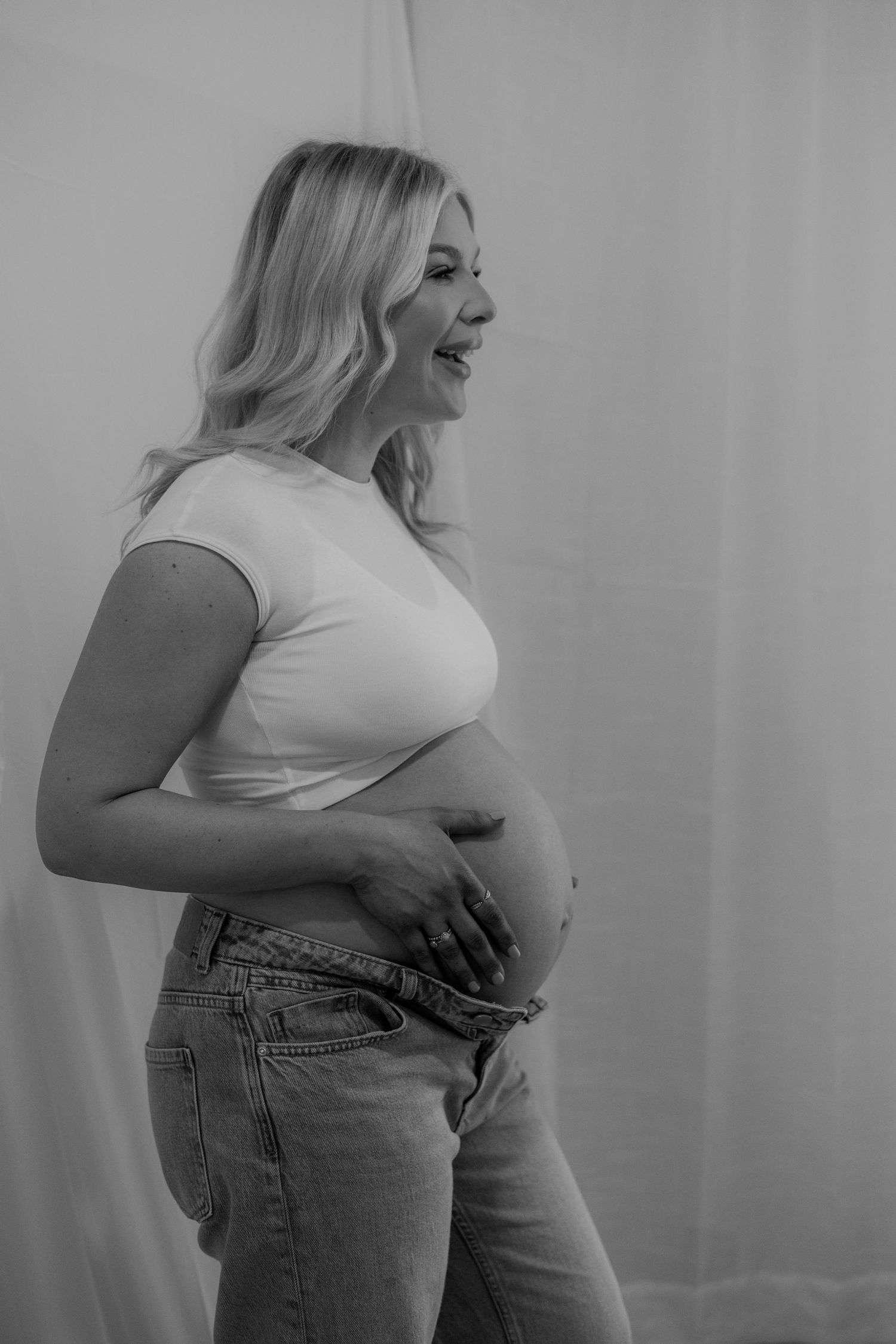 A pregnant mother embracing her beautiful baby bump as part of a maternity photoshoot