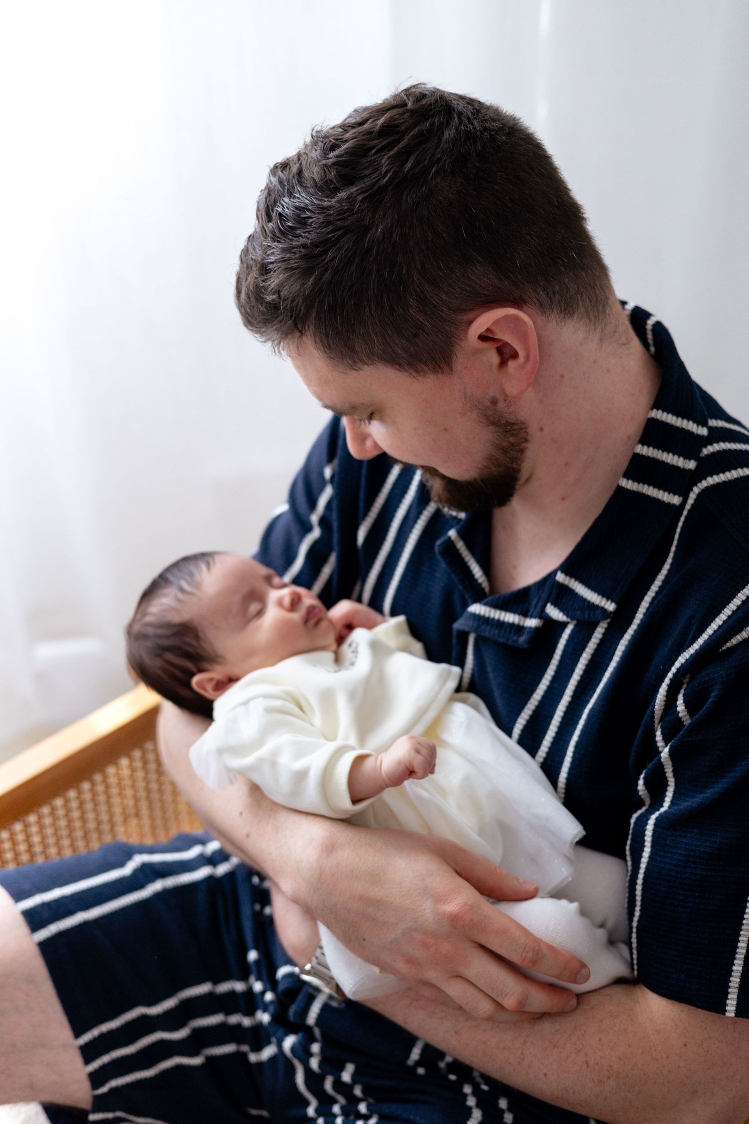 Father holding his baby for a newborn photoshoot