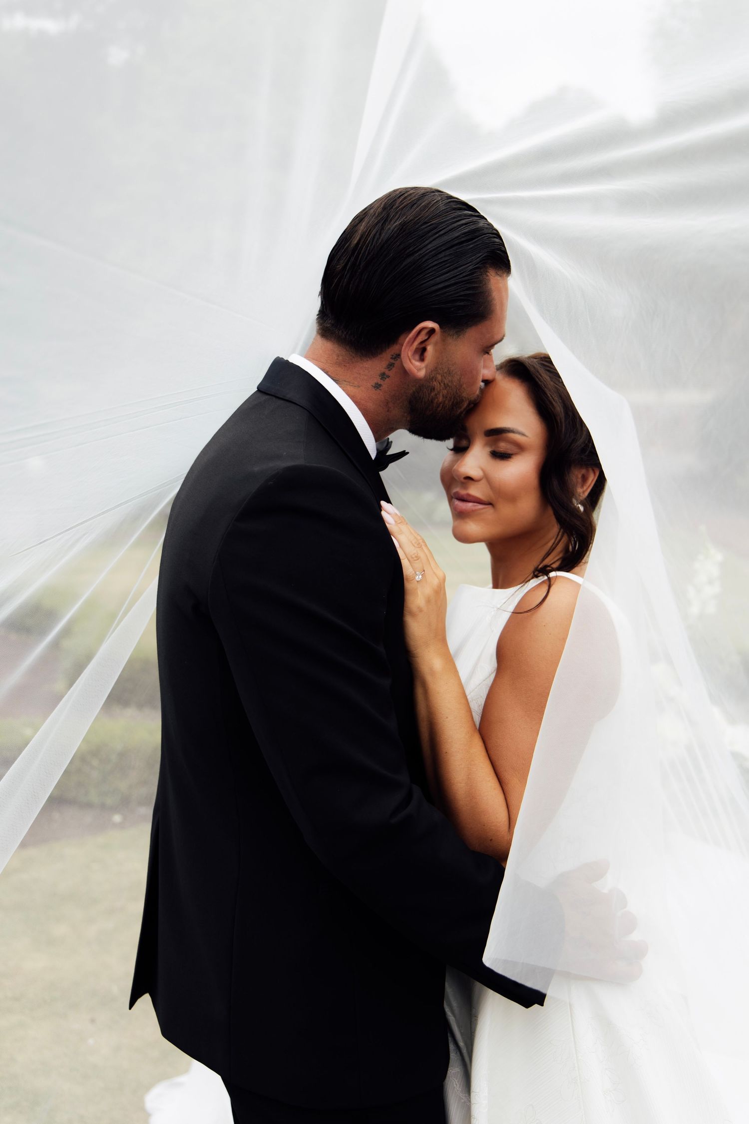 A husband and wife underneath the veil, making for an effortlessly romantic photo.