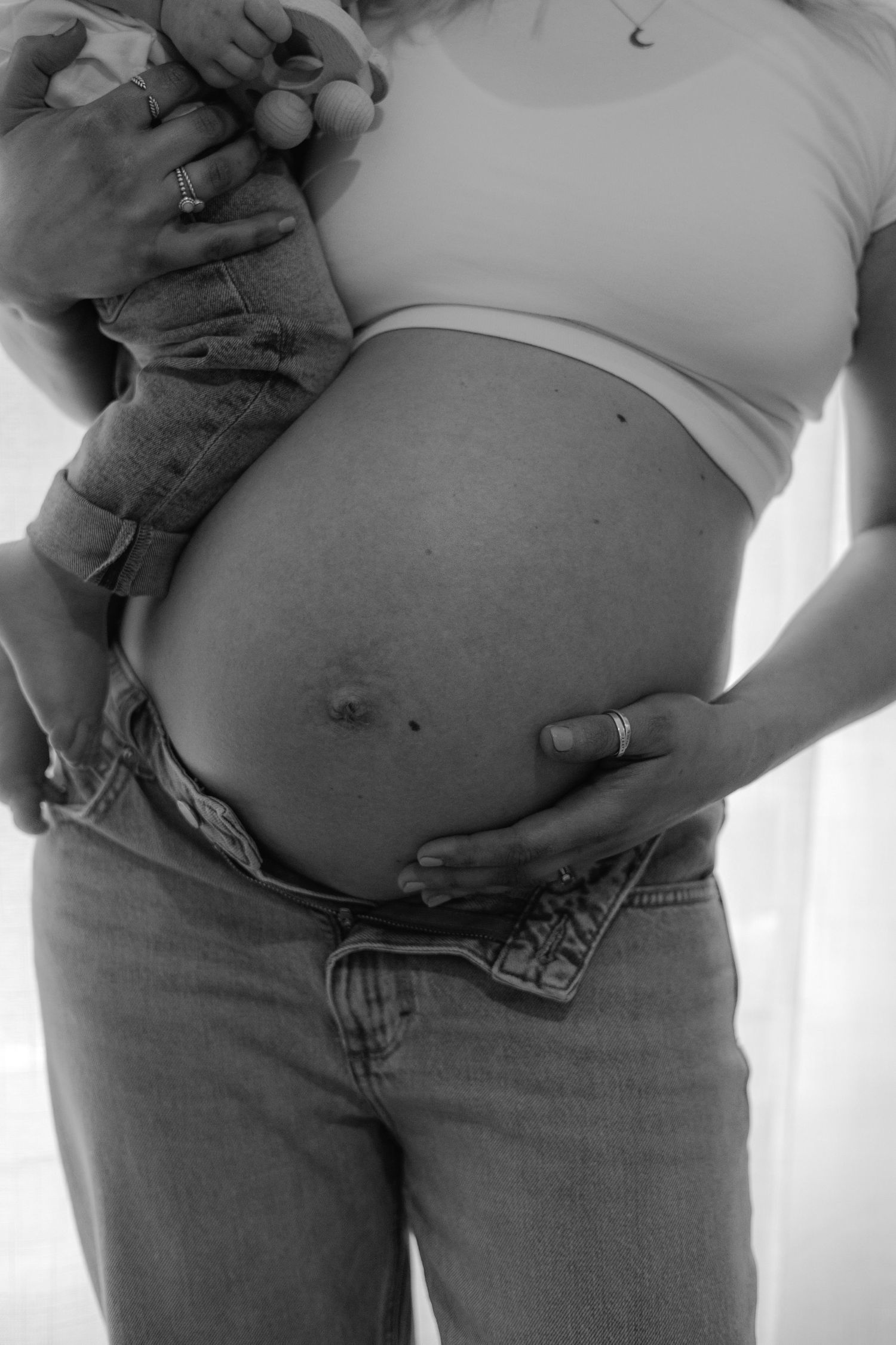A pregnant mother embracing her beautiful baby bump as part of a maternity photoshoot