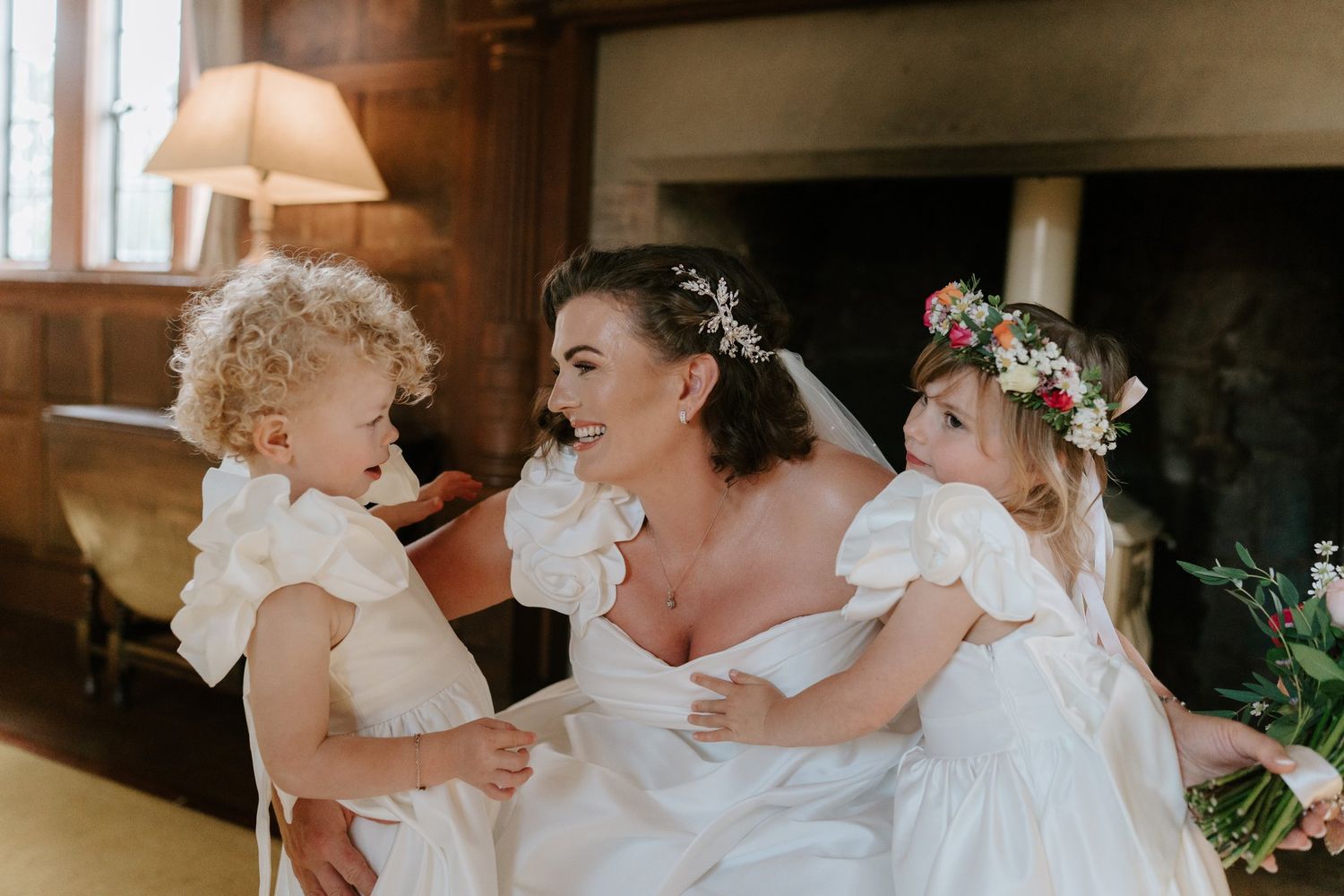 Bride with a flower girl in the library at Brinsop Court