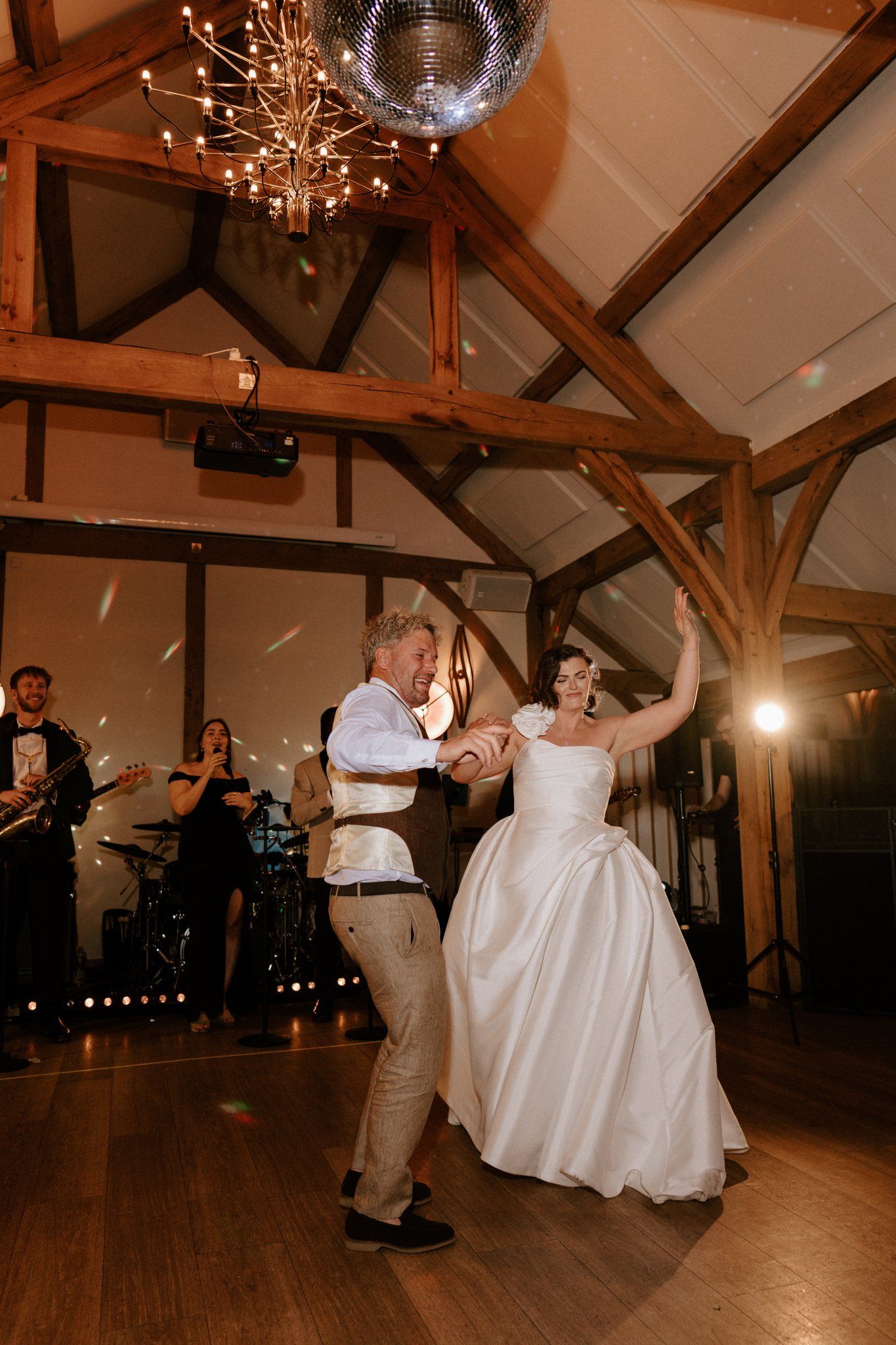 Bride and groom's first dance to a live band in the Knot Barn at Brinsop Court