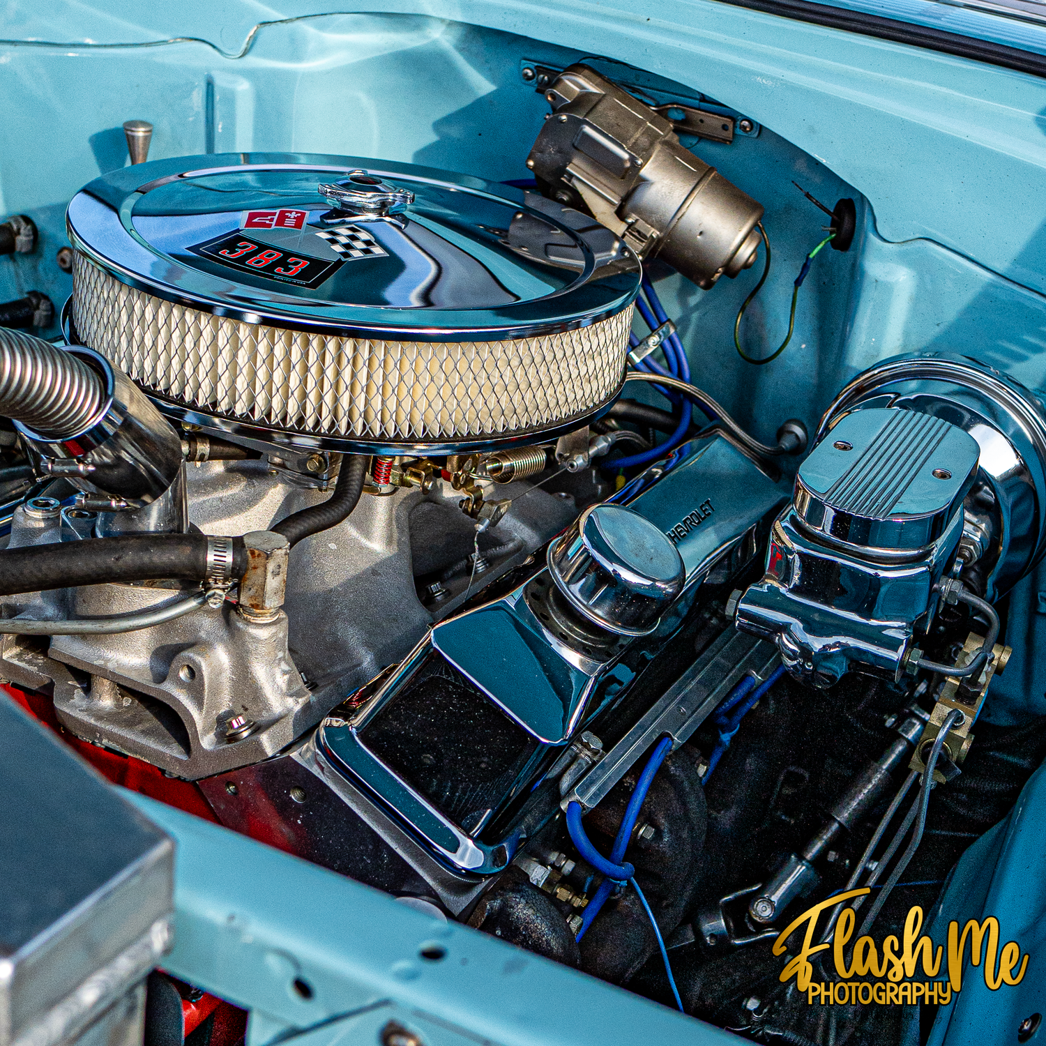 Polished chrome 383 V8 engine with dual carburetors in a classic light blue Chevrolet truck.