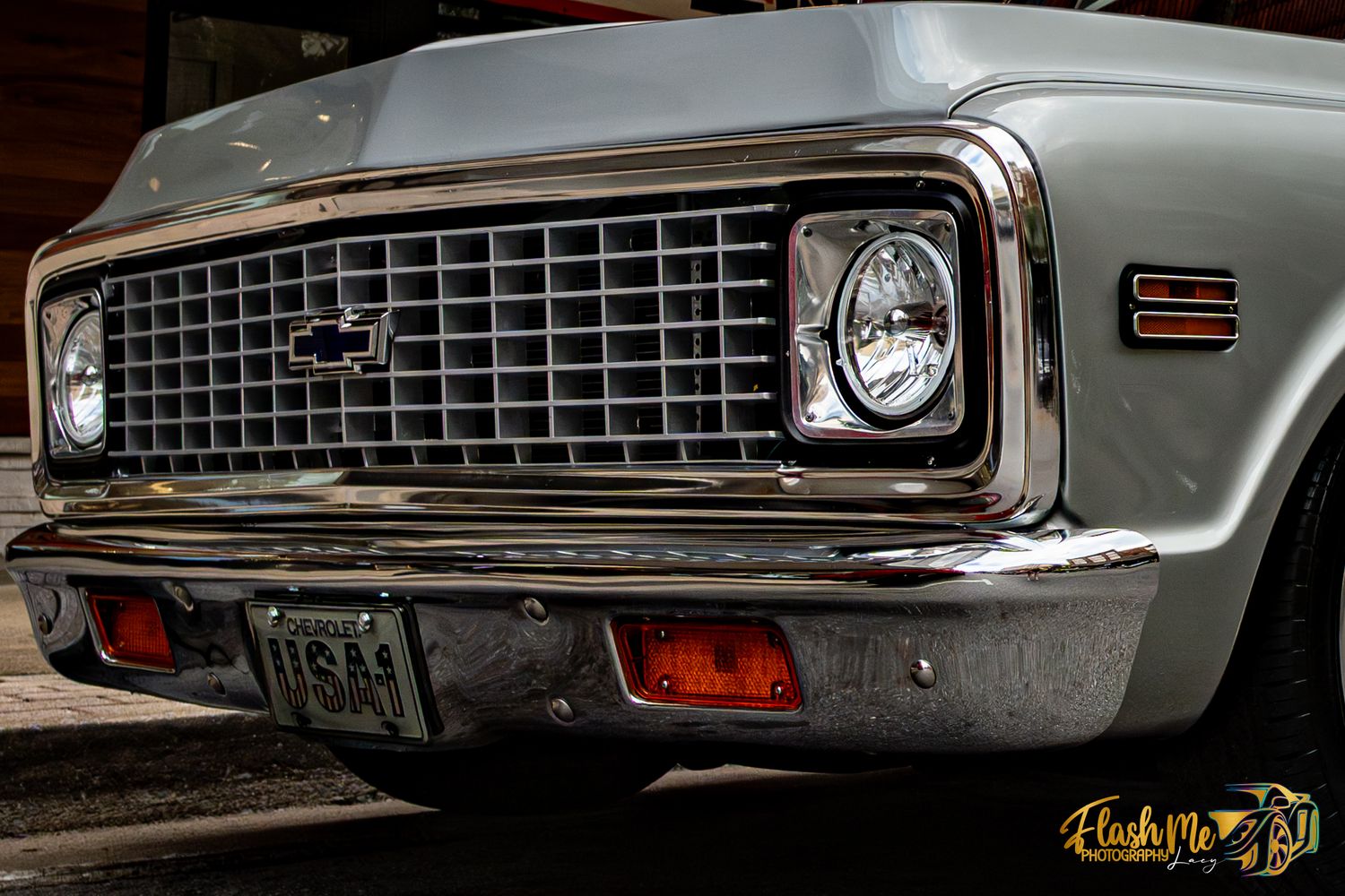 Close-up of a classic Chevrolet truck front grille with chrome details and headlights.