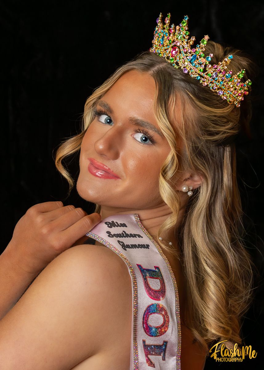 Teen pageant queen wearing colorful crown and Miss Southern Glamour sash in studio portrait.