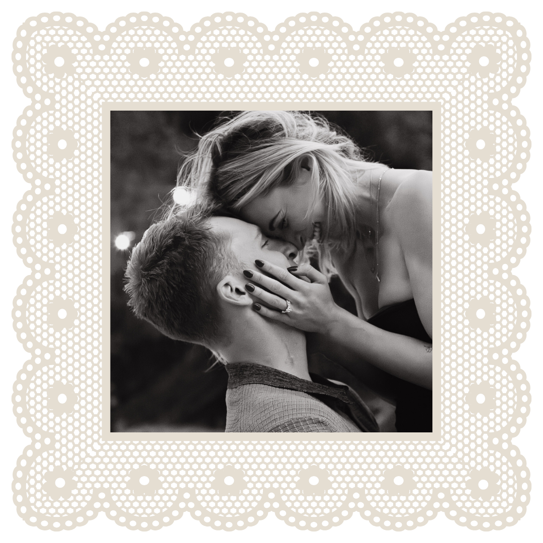 Intimate black and white couple kiss in elegant cream lace-bordered square photo frame.