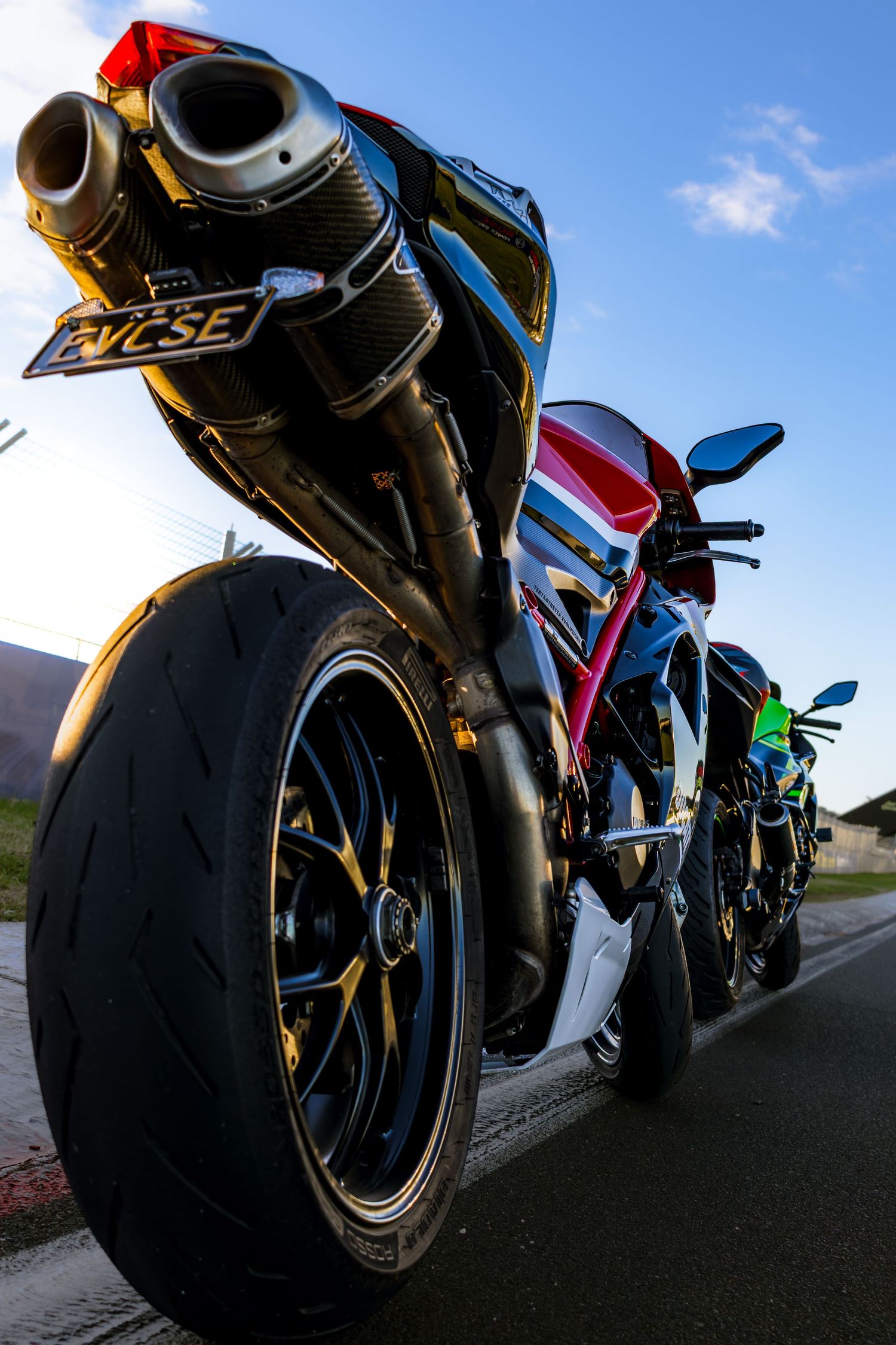 Low angle shot of a red and blue sportbike from behind the rear wheel
