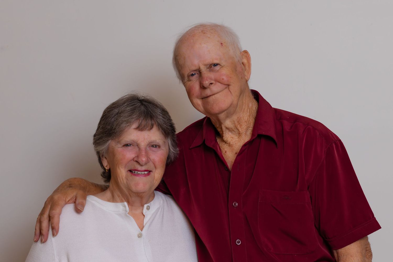 Portrait of an older couple together on a neutral studio backdrop