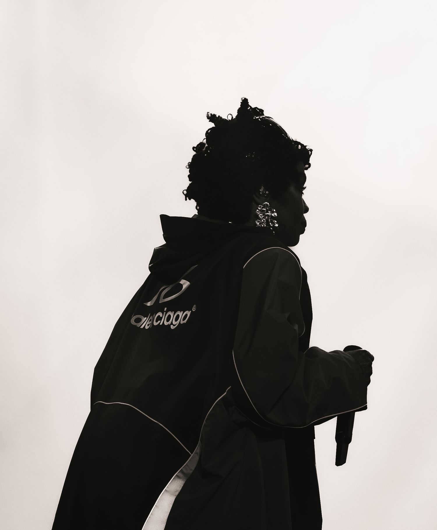 Silhouette of a person wearing a Ciogo branded black jacket, photographed against a white background.