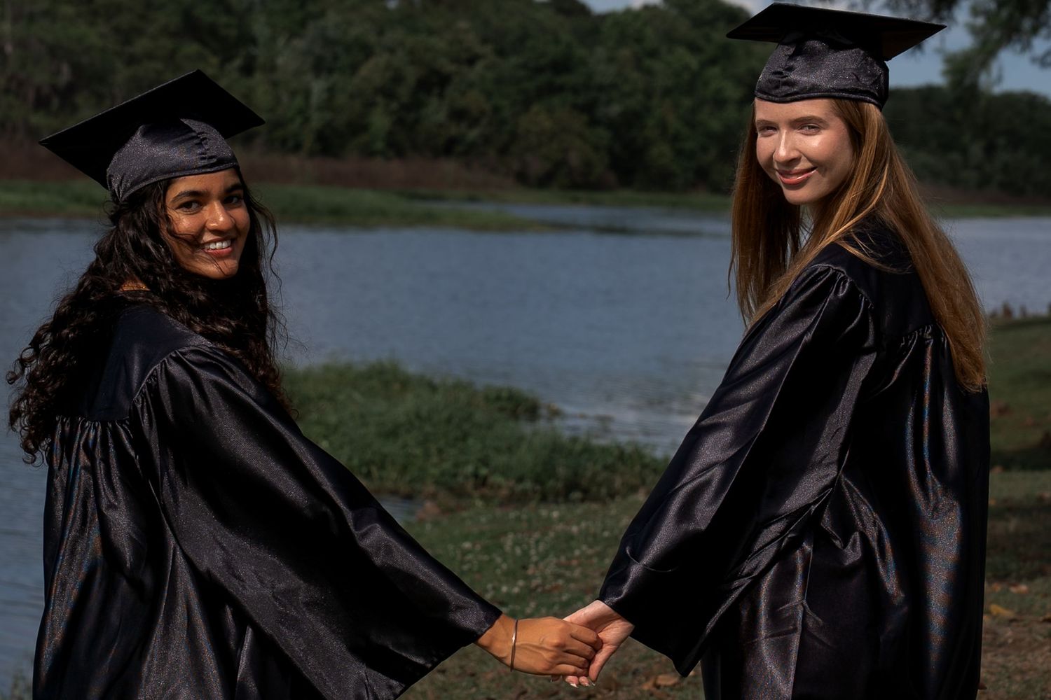 Friends graduating high school. Celebrating holding hands. Senior Session.