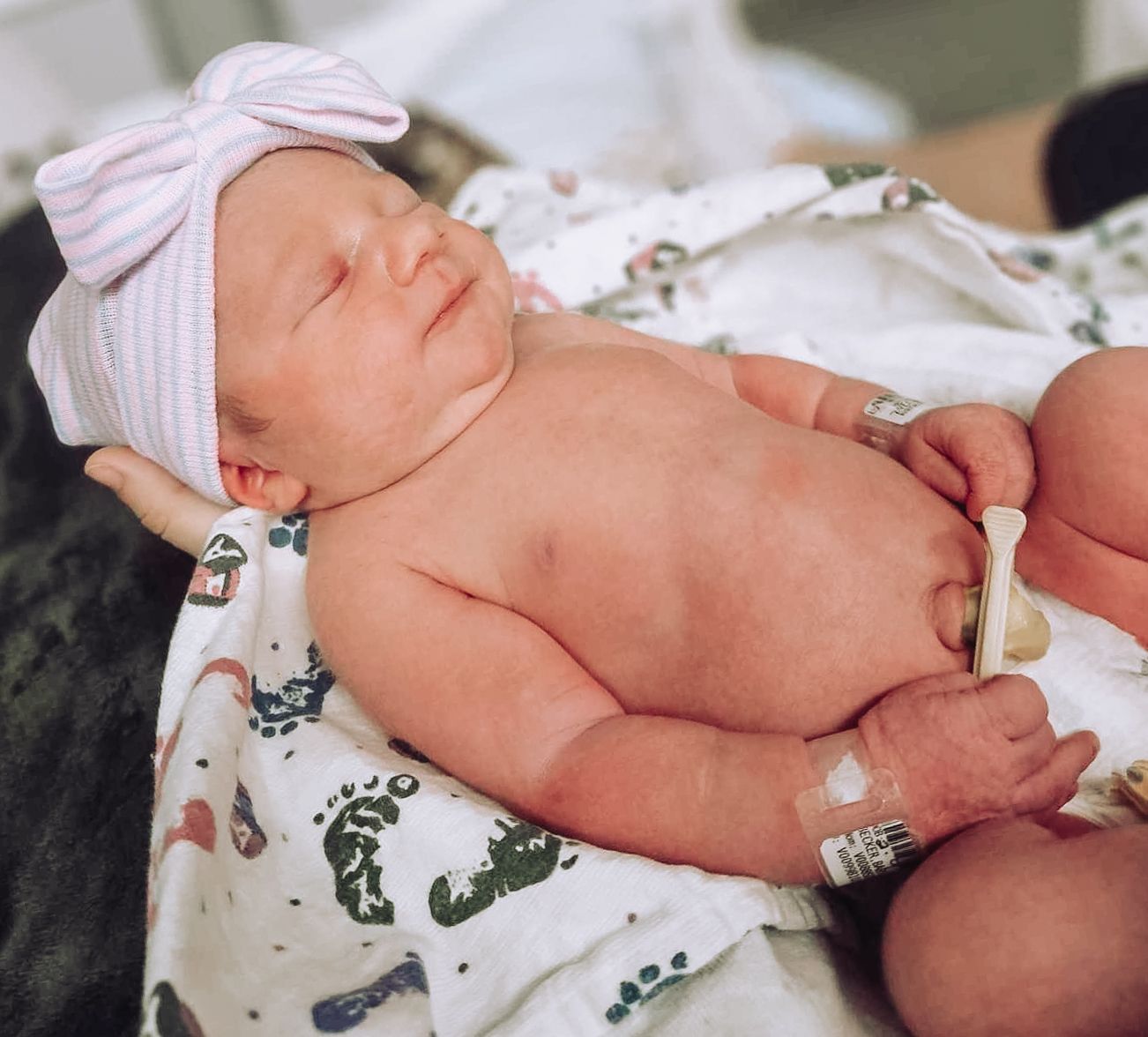 Newborn baby resting on a soft blanket during the first days after birth, captured in natural light