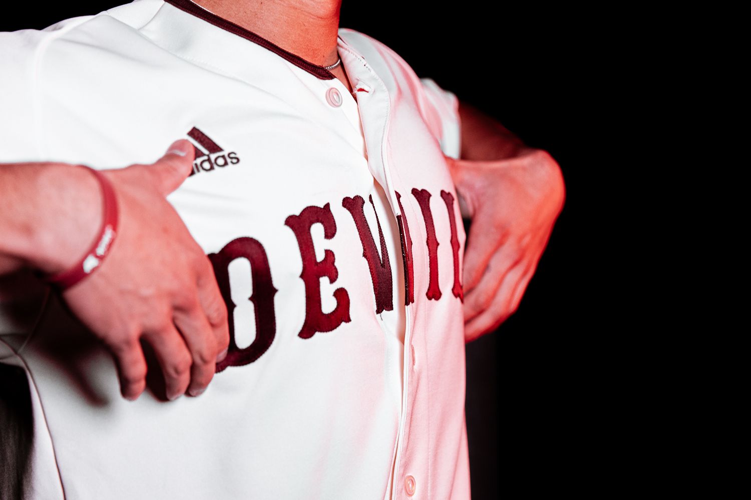 Close-up of an Arizona State Devils white Adidas baseball jersey with maroon lettering.