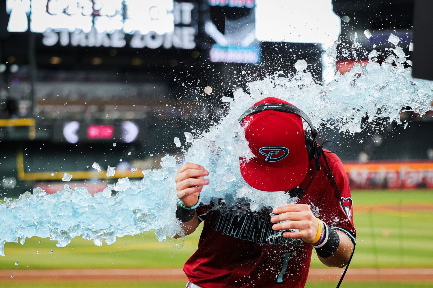 An Arizona Diamondbacks baseball player gets doused with water in a post-game celebration.