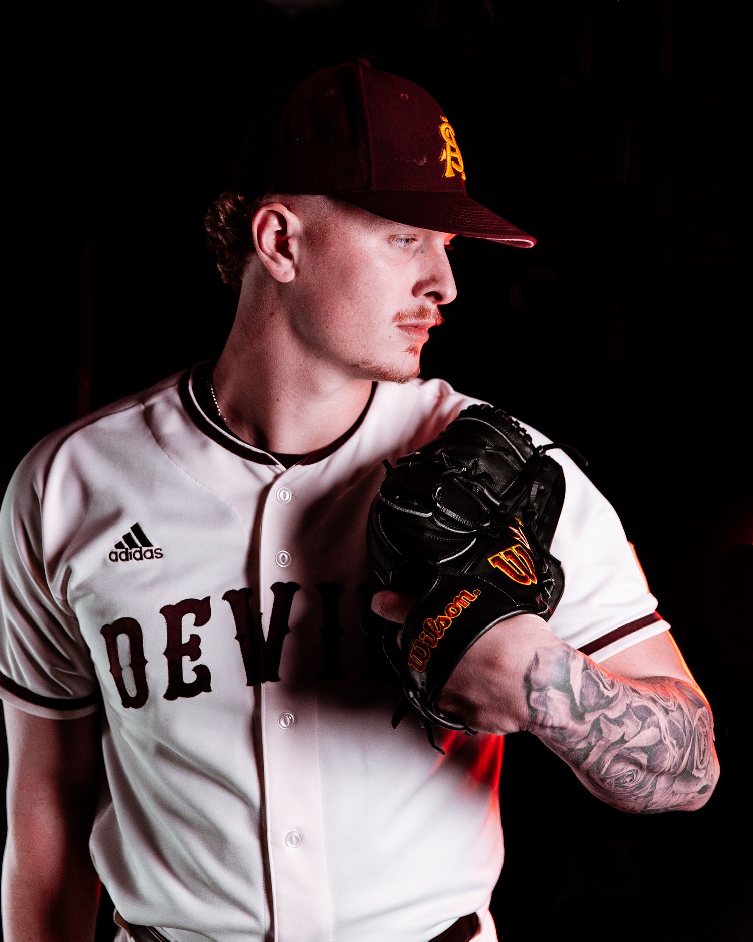 Arizona State Sun Devils pitcher poses with black Wilson glove in white Devils Adidas uniform.