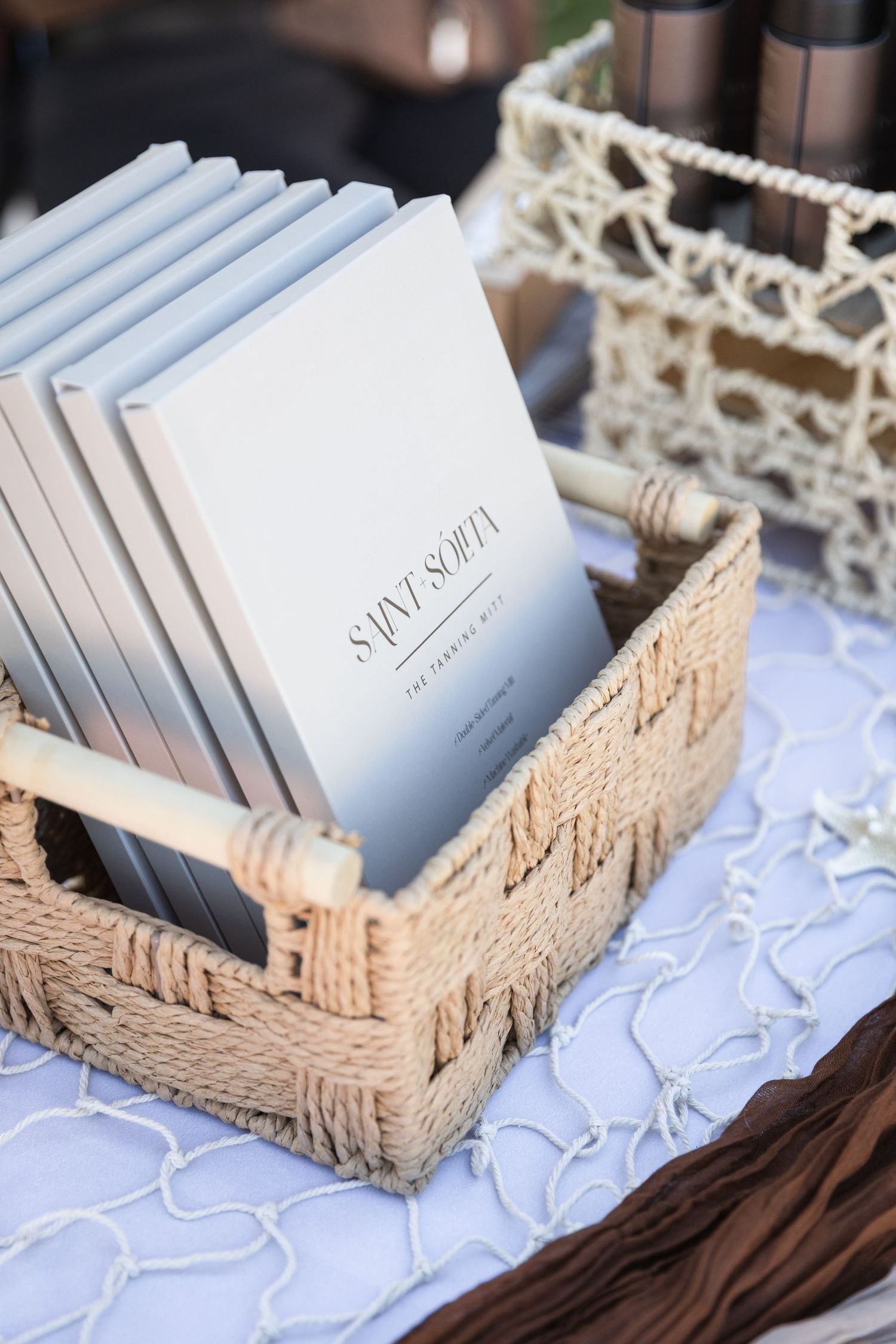 Elegant Saint Softa branded booklets arranged in a woven basket on a decorative table display.