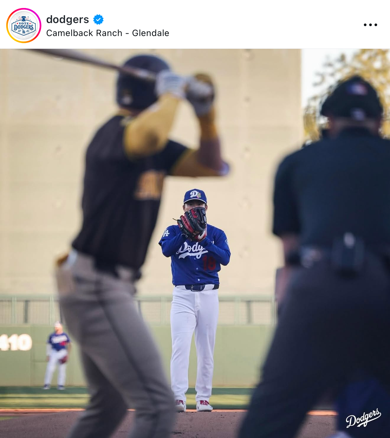 Los Angeles Dodgers coach stands on field at Camelback Ranch during spring training in Glendale.