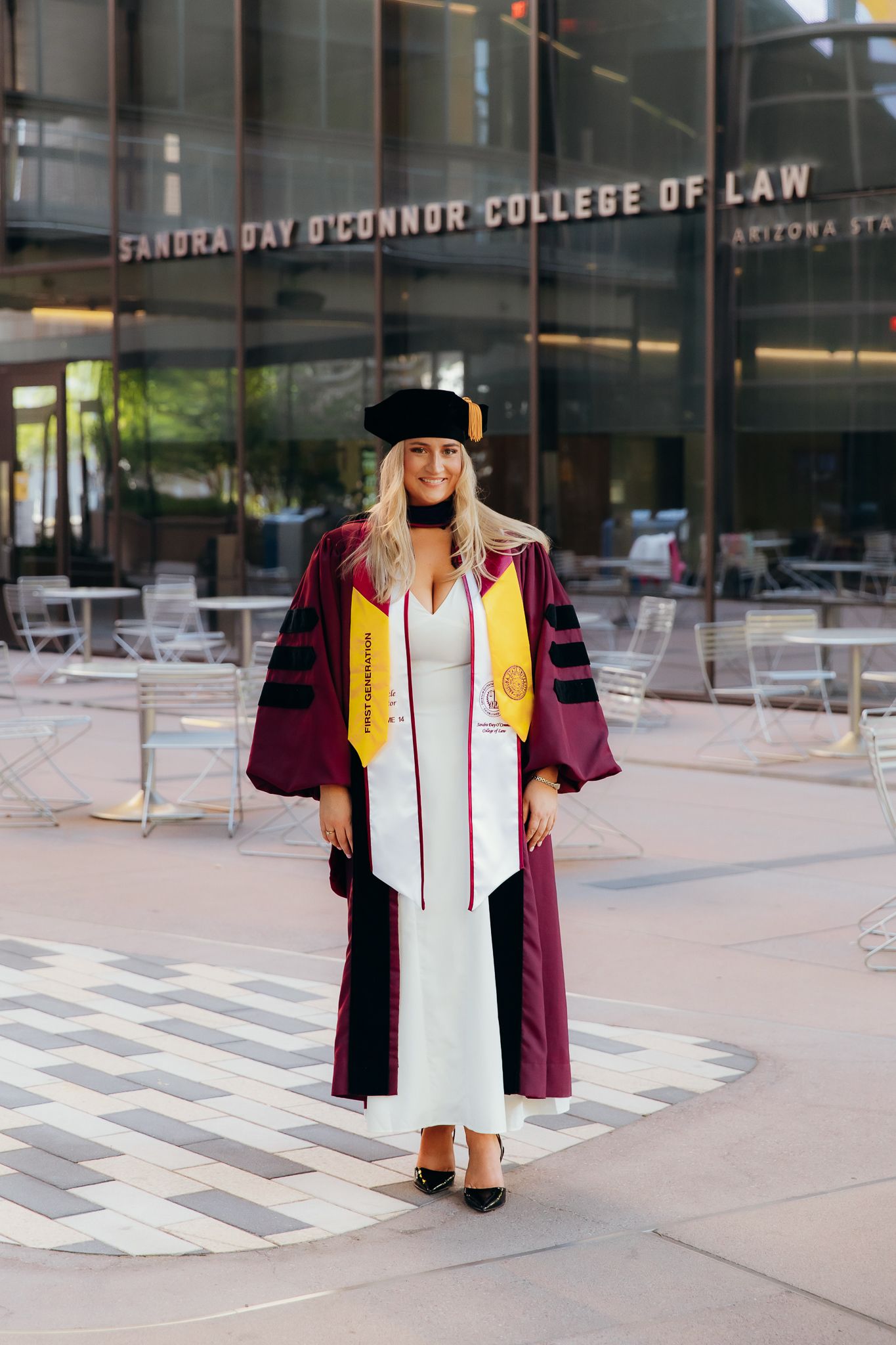 Law graduate in maroon robes at Sandra Day O'Connor College of Law ASU.