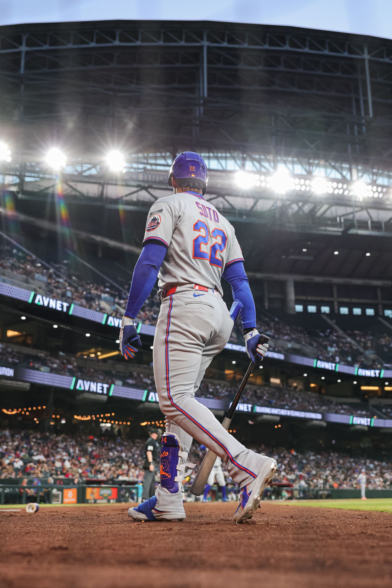 New York Mets player #22 Starling Marte stands at bat in a dramatic stadium lighting scene.
