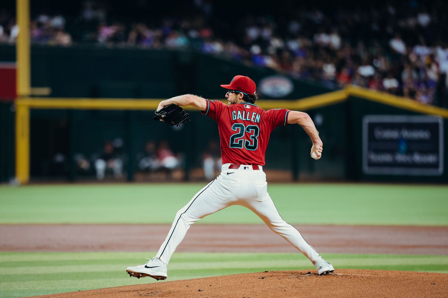 Arizona Diamondbacks pitcher Gallen #23 delivers a pitch in red uniform during an MLB home game.