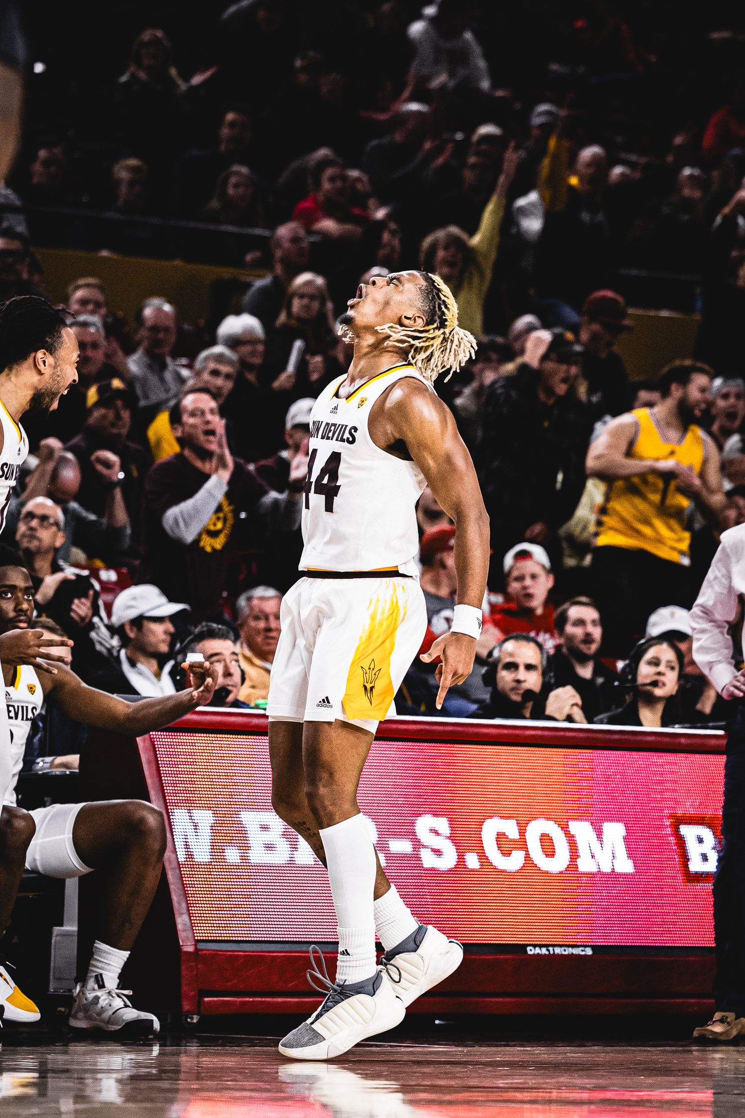 Arizona State Sun Devils basketball player #14 celebrates looking skyward during an ASU home basketball game.