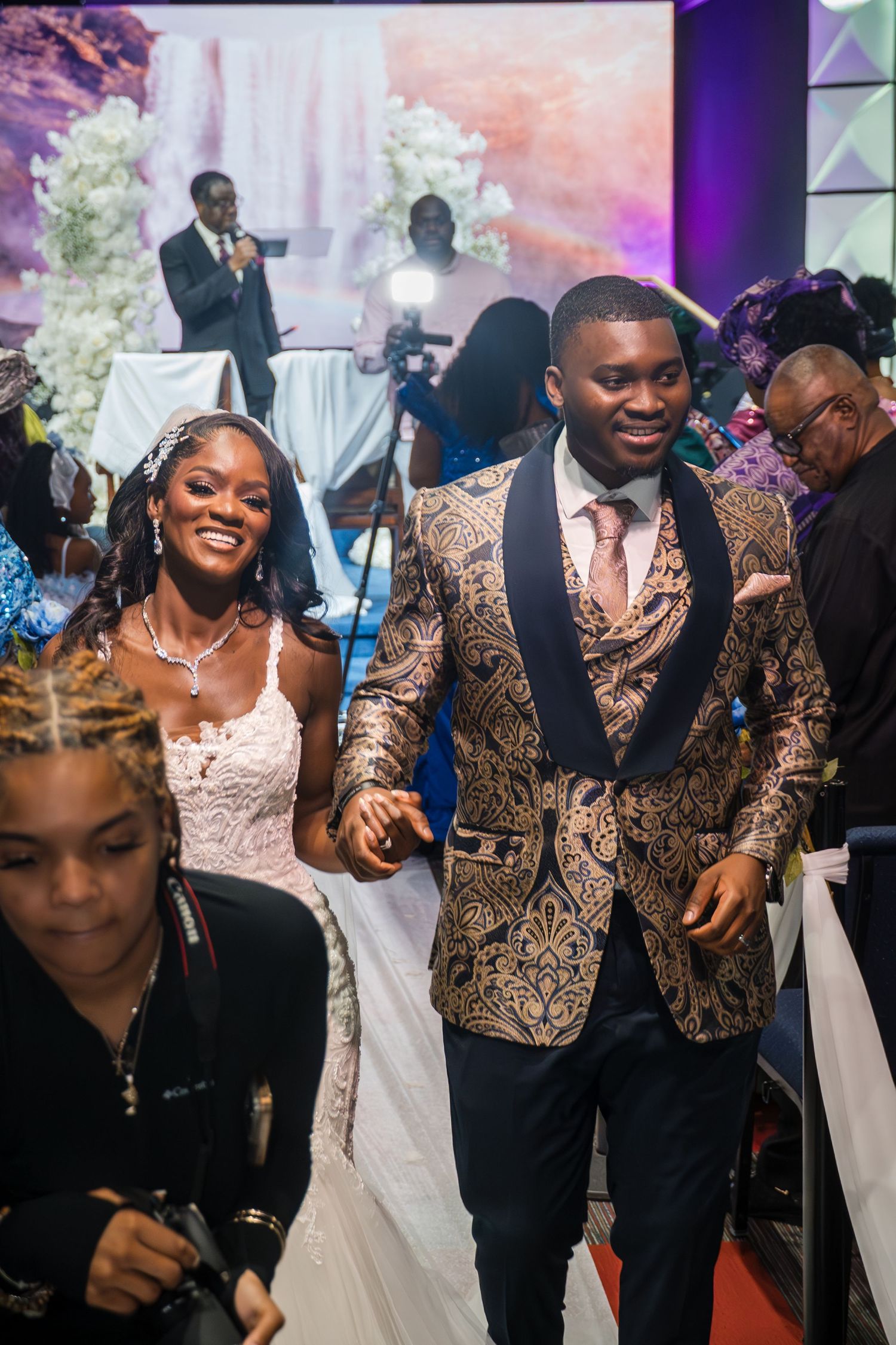 Bride, groom, and wedding party dancing and celebrating together