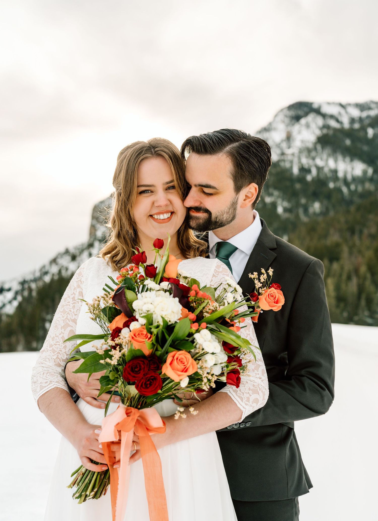 Groom snuggling his bride at Tibble Fork Reservoir, Utah