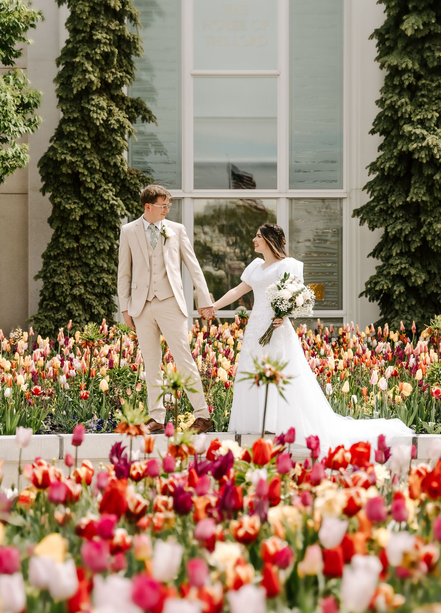 A newly married bride and groom in the tulip garden at the Mount Timpanogos, Utah LDS Temple