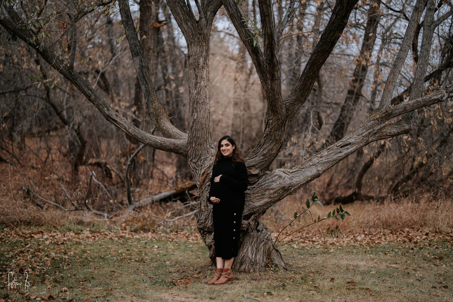 A series of moody forest photographs showing a figure in black clothing among bare winter trees and fallen leaves.