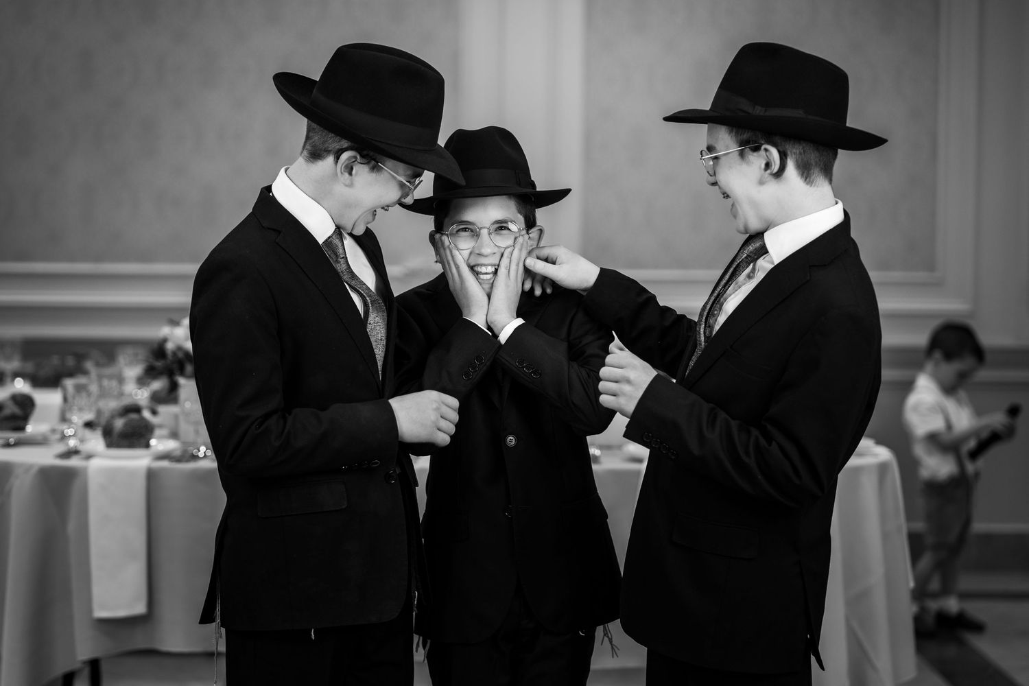 Black and white photo of people in traditional dress having animated conversation.