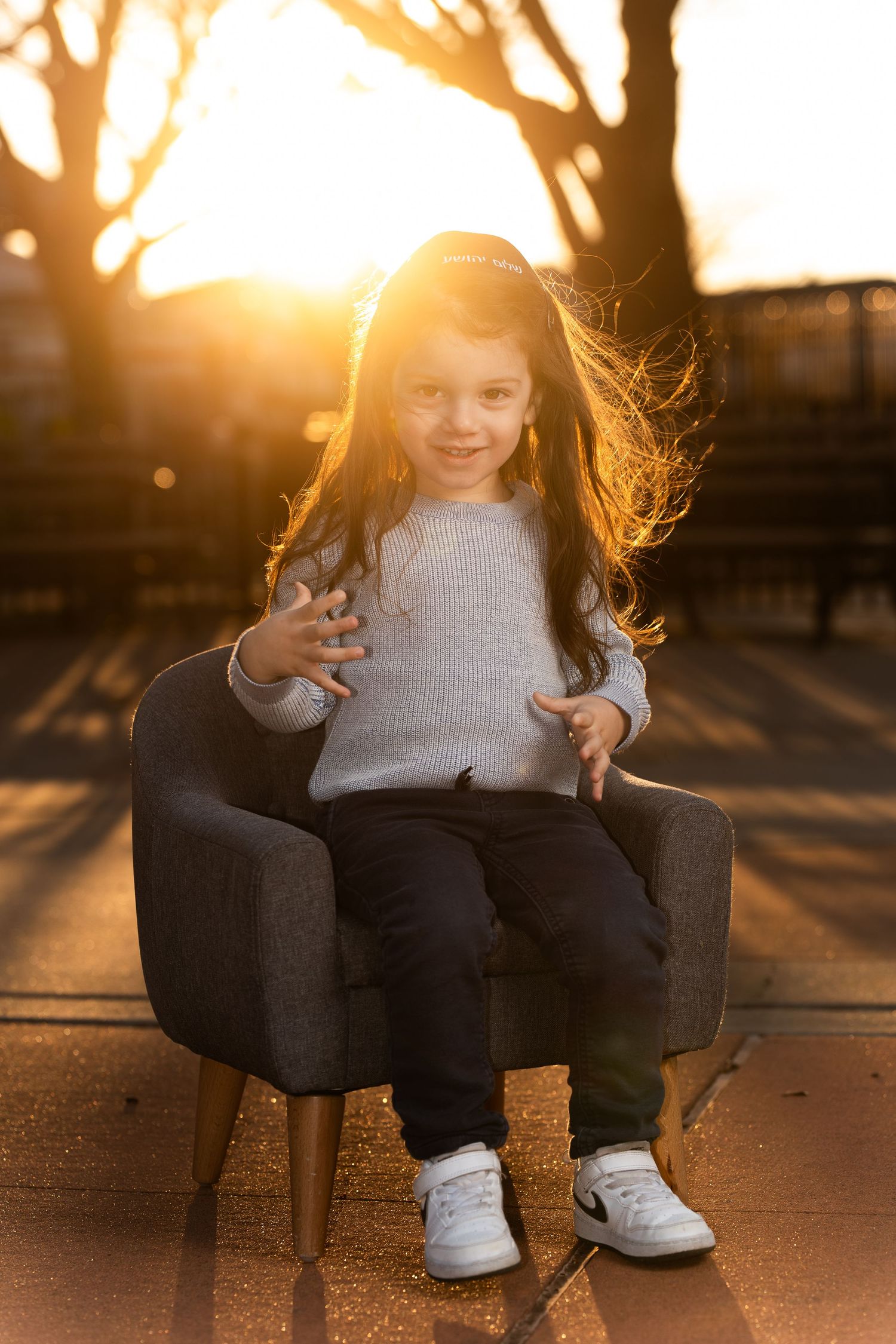 Close-up shots of white sneakers on a swing at sunset with golden light filtering through.