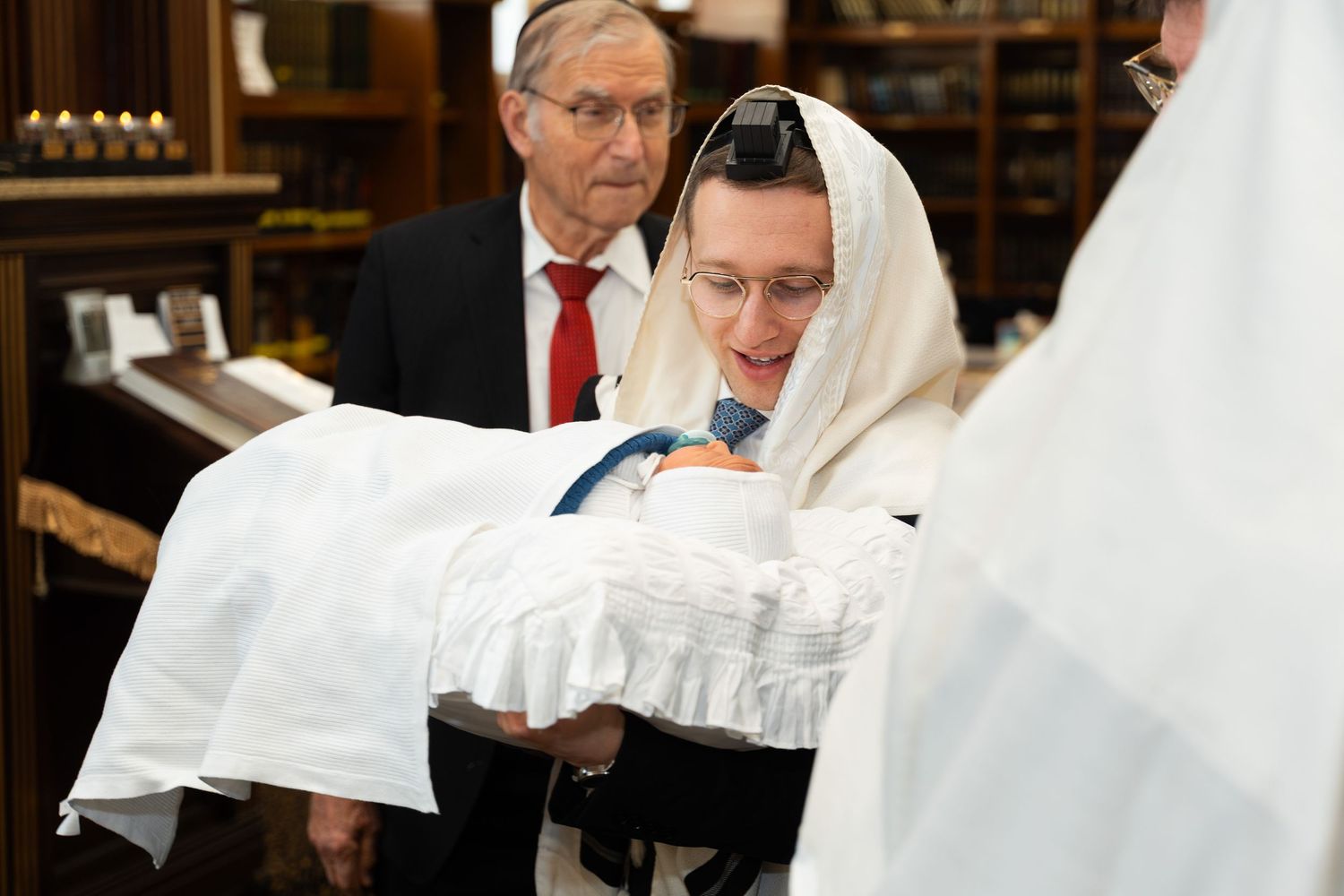 Medical professionals in white coats examine paperwork in a clinical setting.
