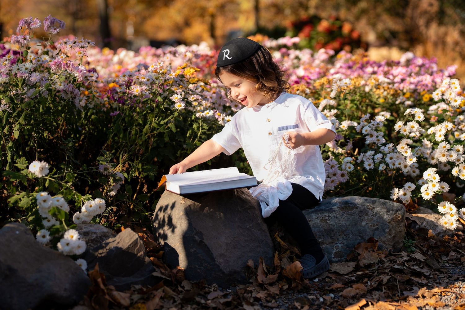 Romantic outdoor photo session in a blooming flower garden during golden hour.