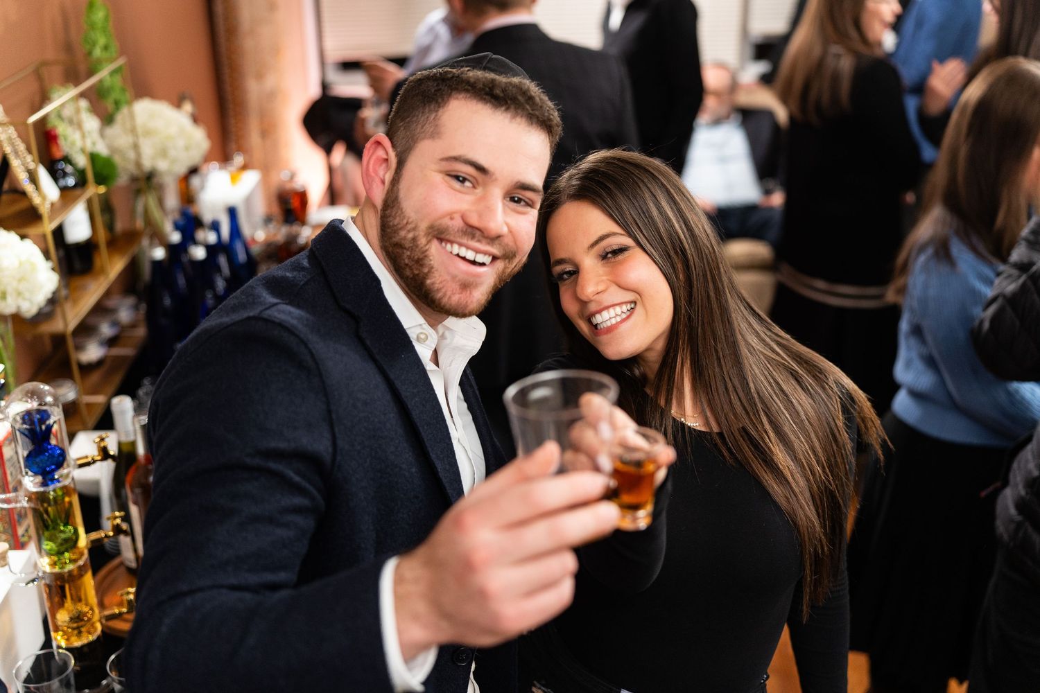 A celebratory moment at a bar with drinks and smiles.
