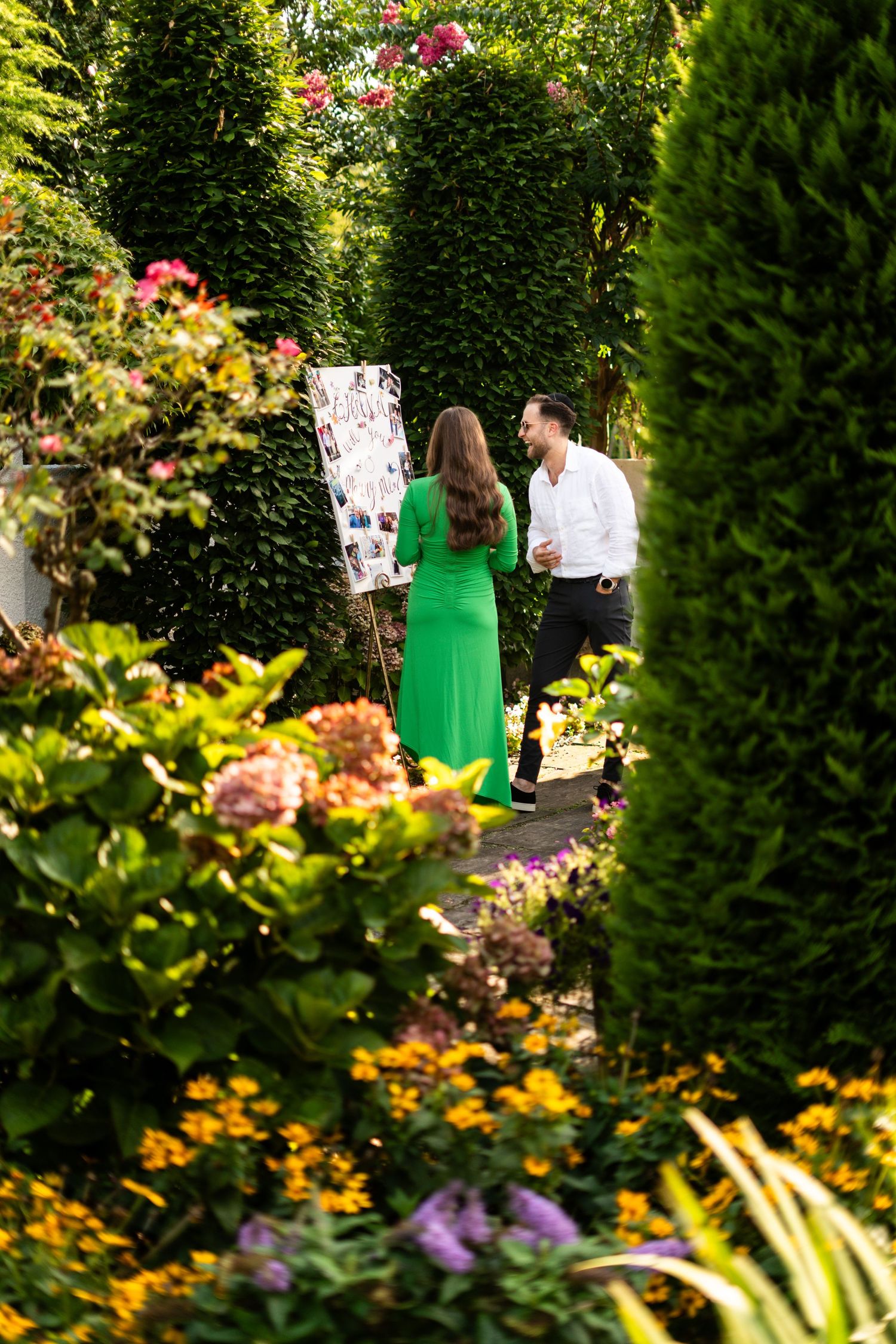 Beautiful garden photoshoot setting with lush greenery and colorful flowers in bloom.