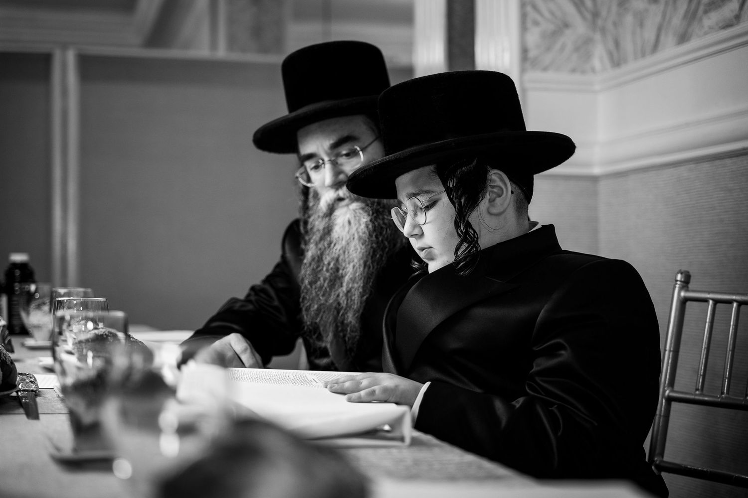 Orthodox gathering showing traditional dress and hats in monochrome photography.