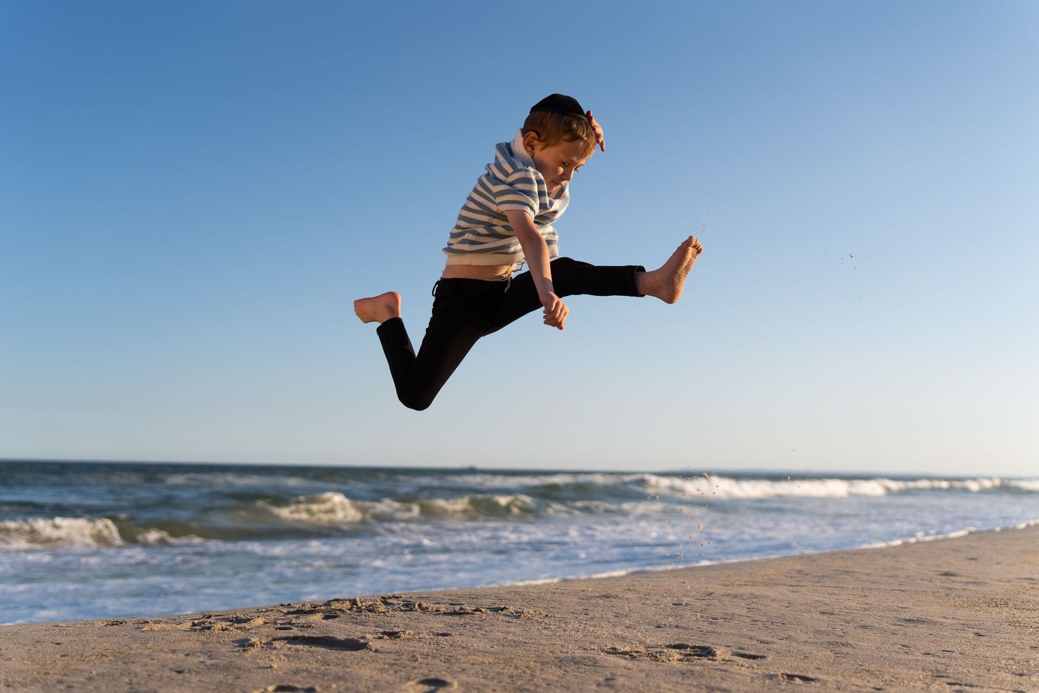 A sequence of photos showing someone jumping and doing acrobatic moves on a beach at sunset.