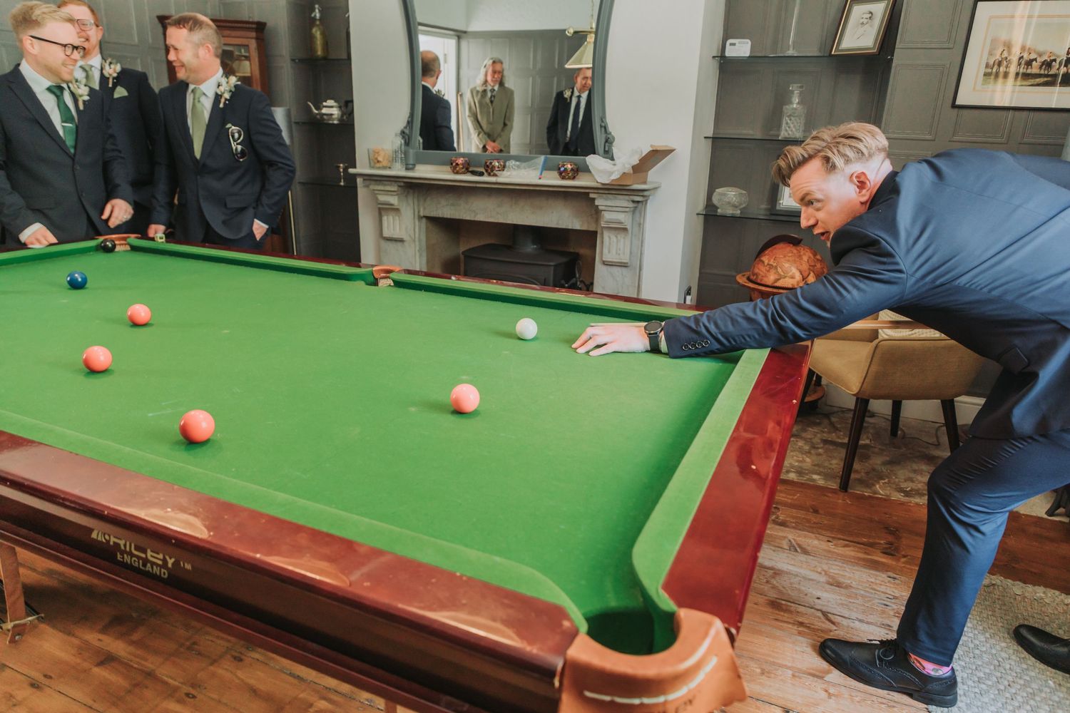 People playing snooker on a green felt table in a series of action shots showing different angles and positions.
