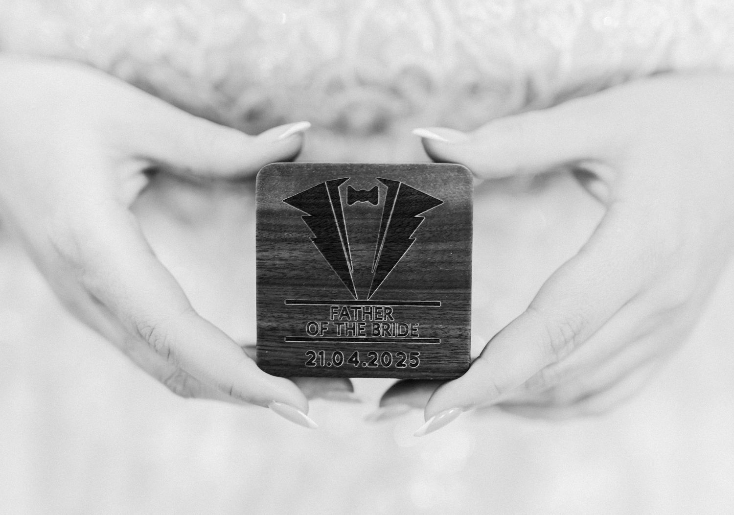Black and white photo series showing hands holding and displaying a vintage Art Deco style metal brooch.
