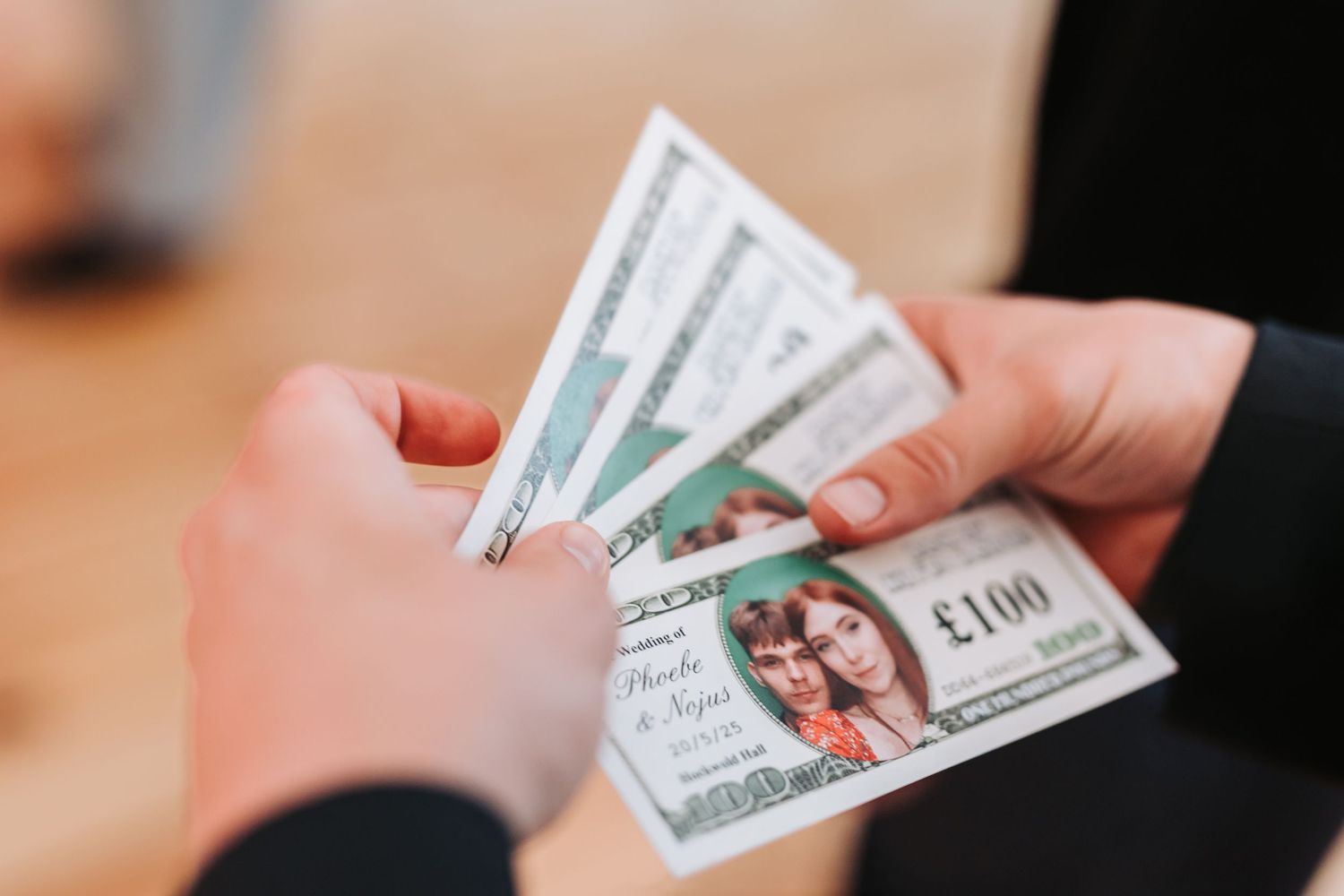 Close-up view of hands exchanging US dollar bills in a financial transaction.