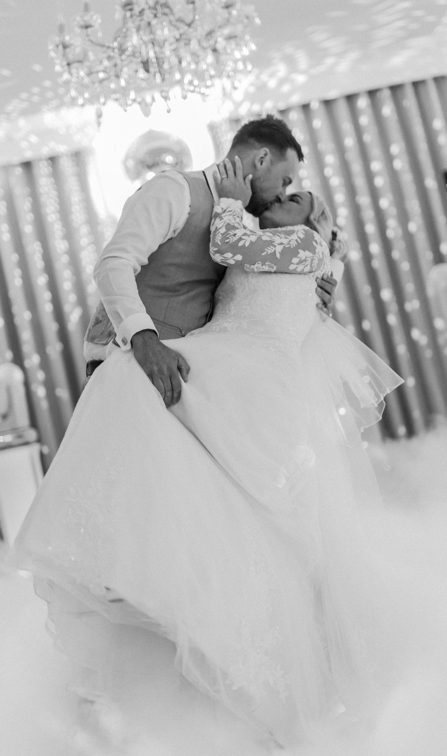 A romantic black and white photo series showing a couple in wedding attire sharing intimate moments on their special day.