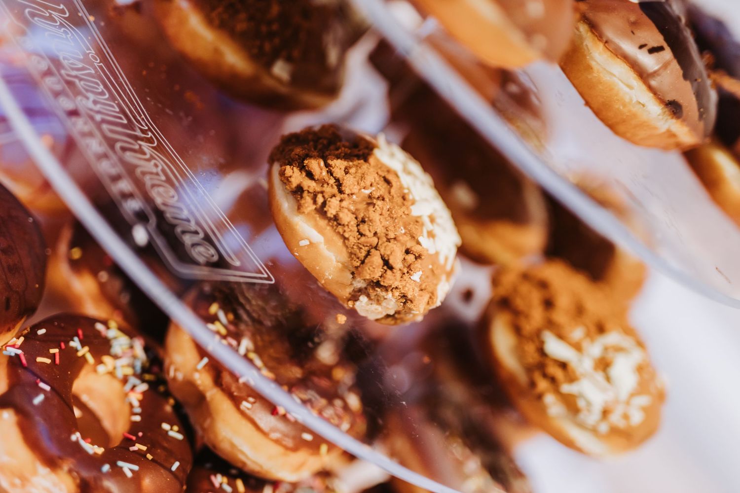 Chocolate chip cookies drizzled with white chocolate and caramel sauce arranged in a diagonal pattern.