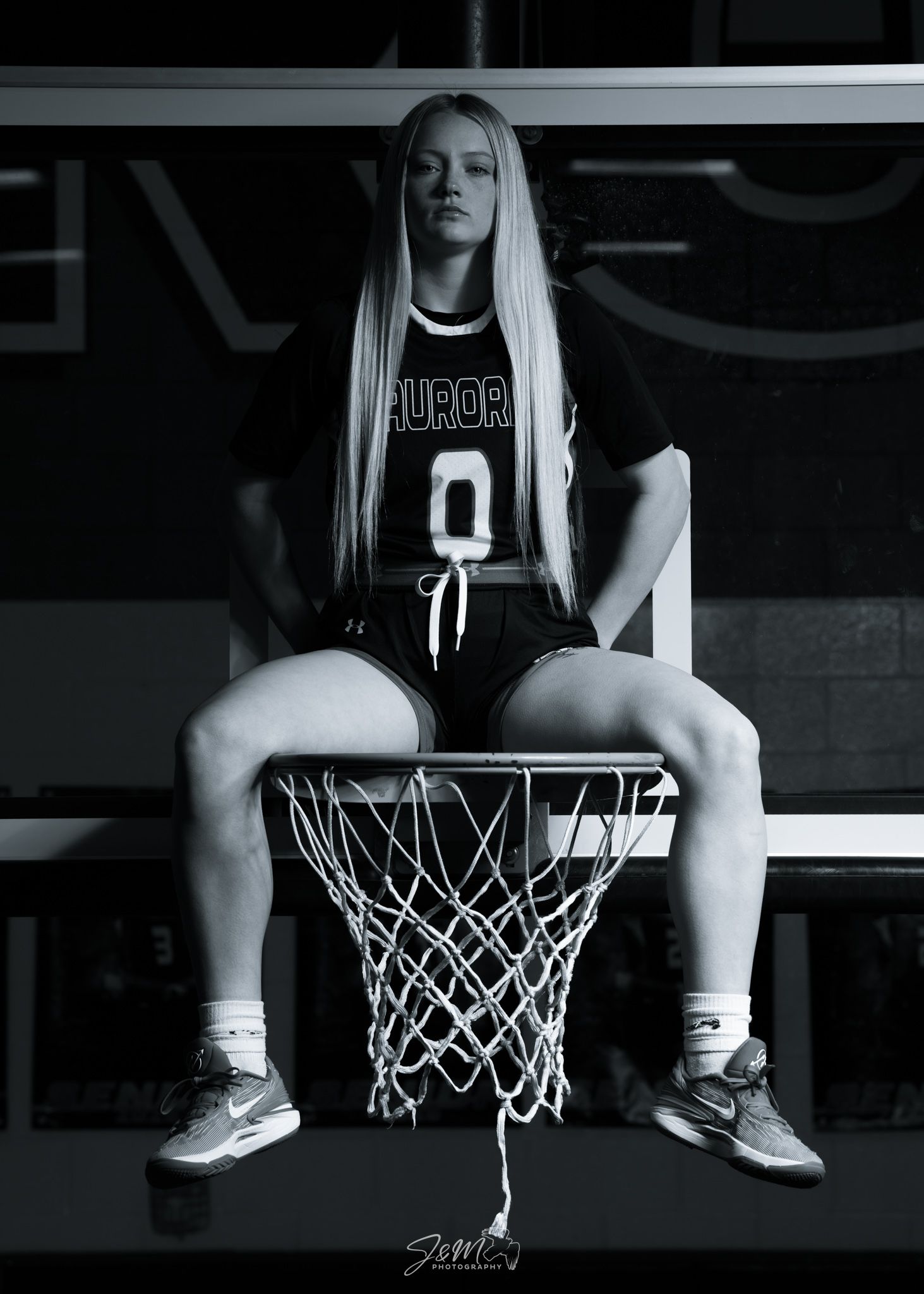 Black and white basketball themed portrait sitting on a hoop net.