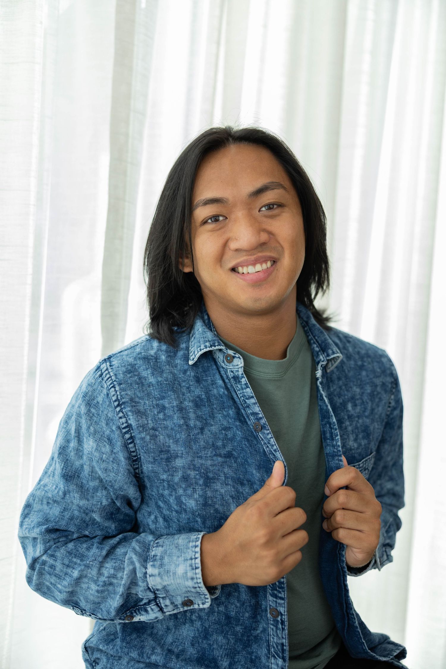 Energetic photo sequence showing person posing in acid wash denim jacket and green turtleneck against white backdrop.