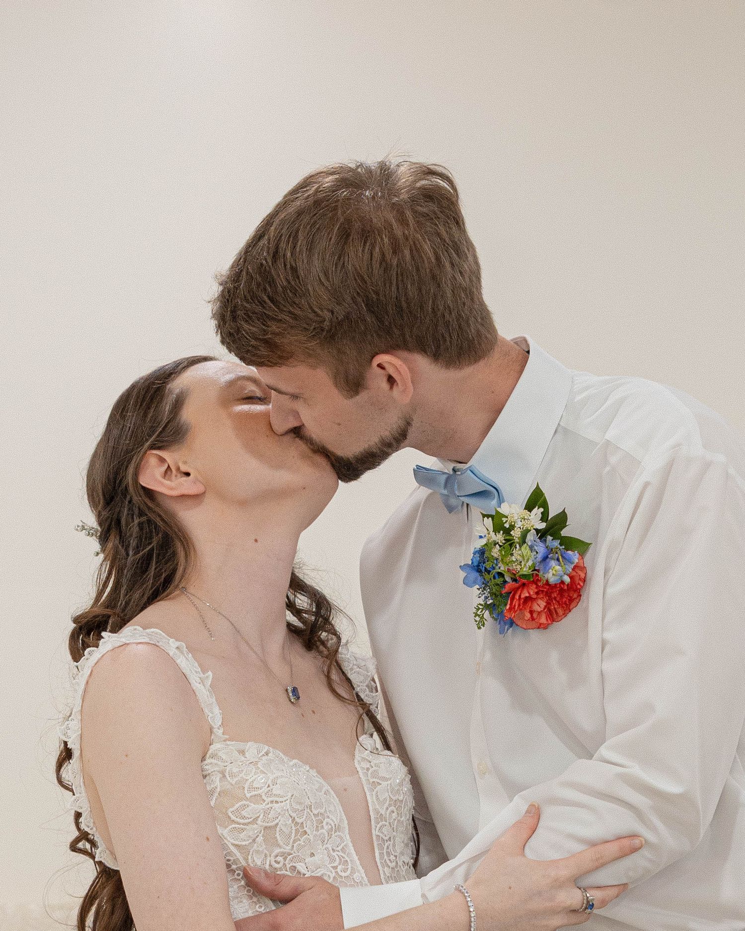 A bride and groom share four intimate kisses in a series of romantic wedding portraits against a neutral background.