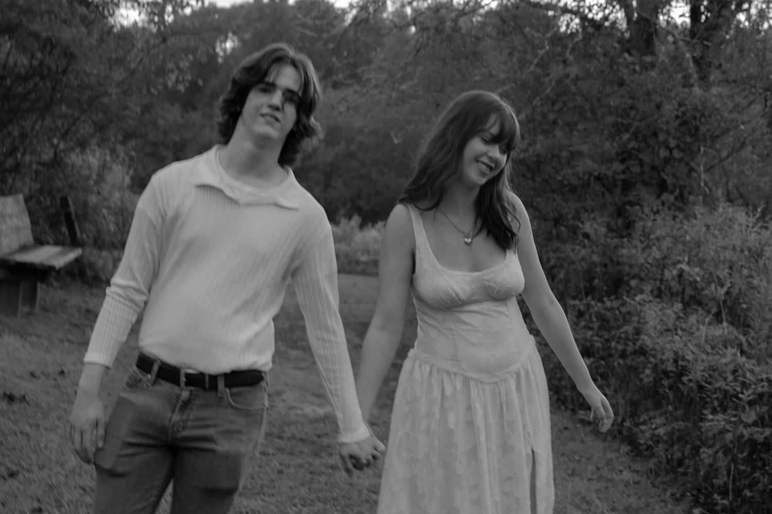 Black and white photo collage showing couple walking and dancing together on a wooded path.