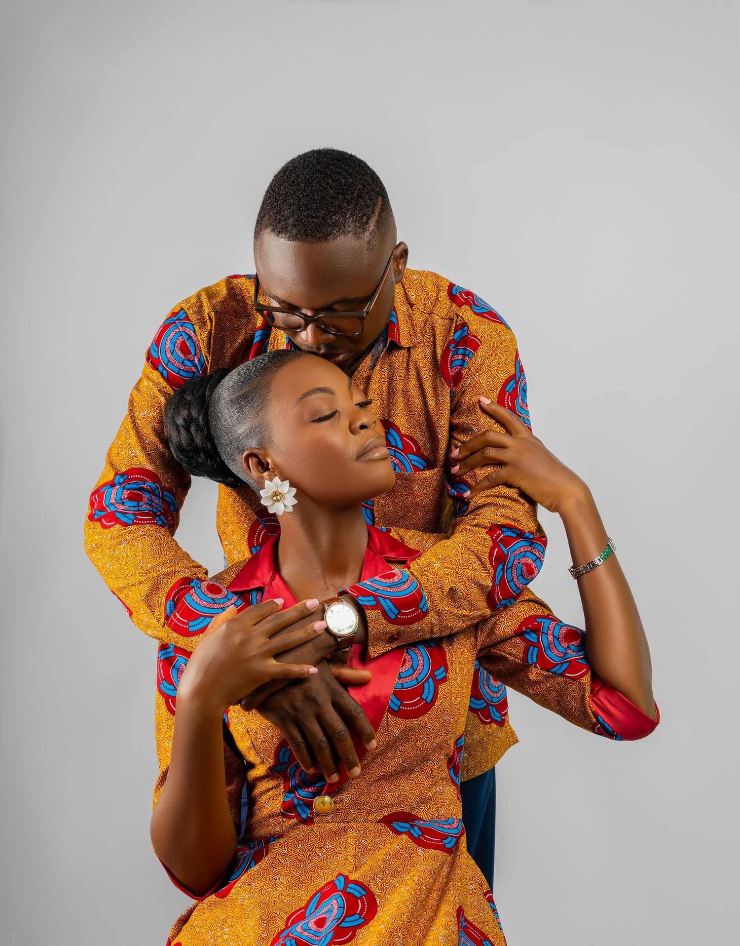 A series of fashion photos showing a person in a vibrant yellow and blue African print dress posing against a gray backdrop.