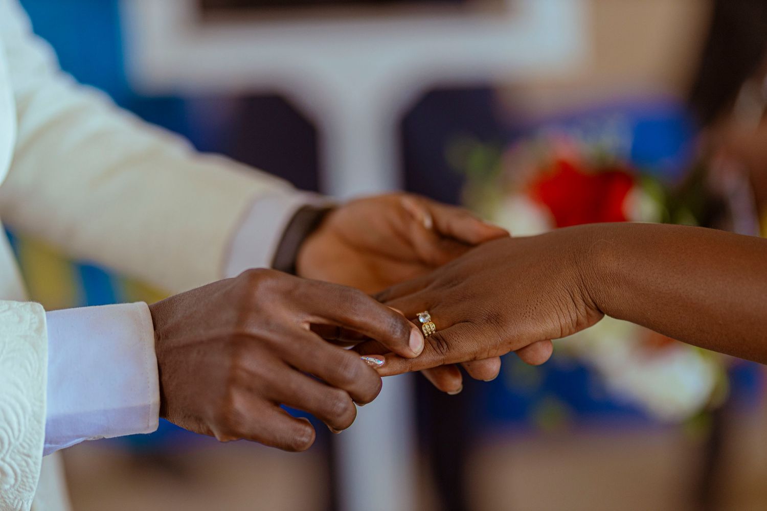 Wedding ring exchange close-up showing hands during the ceremony.