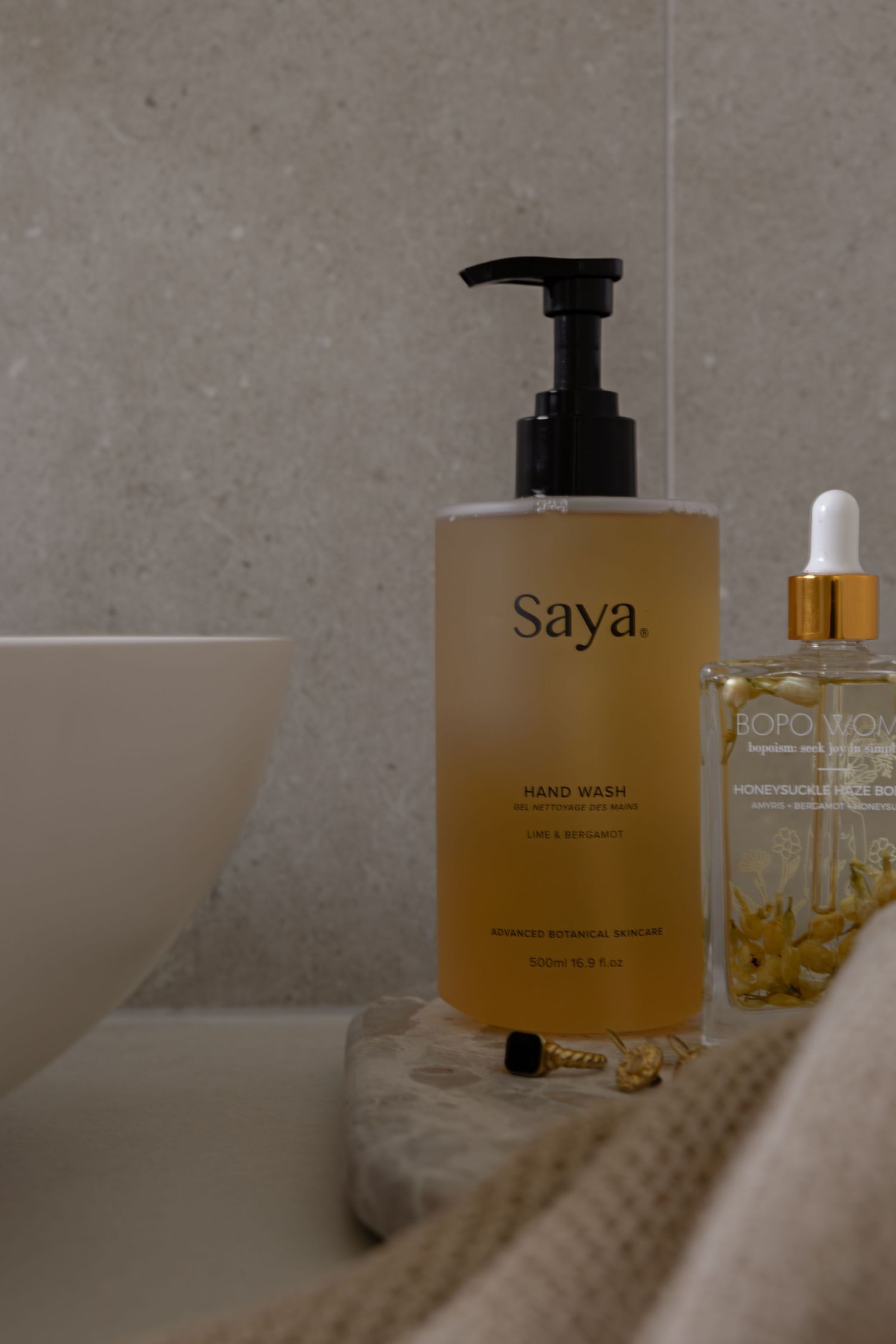 Luxury skincare products displayed on white surface with minimalist aesthetic and soft lighting.
