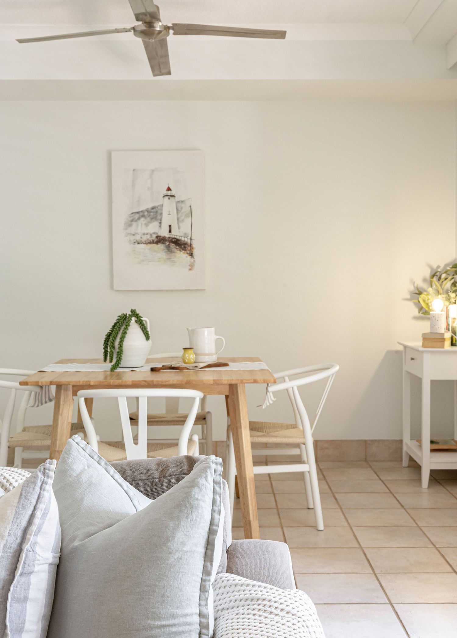 Bright modern cafe interior with wooden tables and white chairs showing a clean minimalist Scandinavian design style.