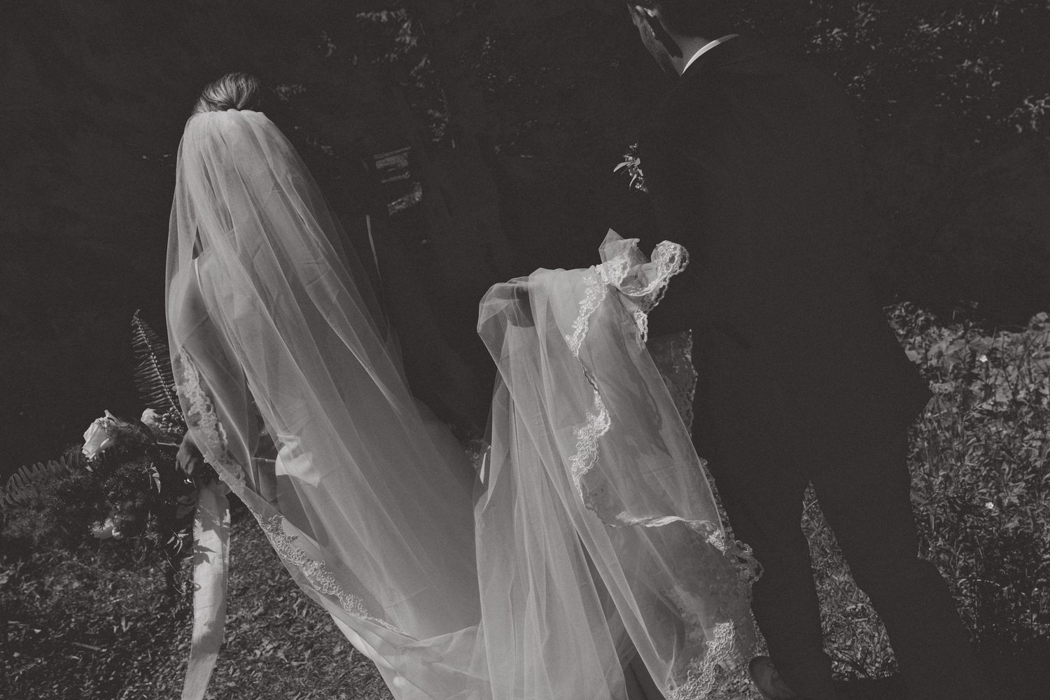 Flowing white wedding veil captured in black and white photography.